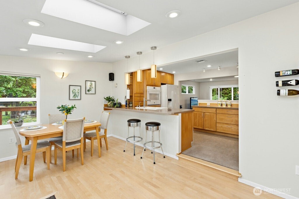 Skylights and windows all around in the sunroom which includes the counter/bar area to kitchen