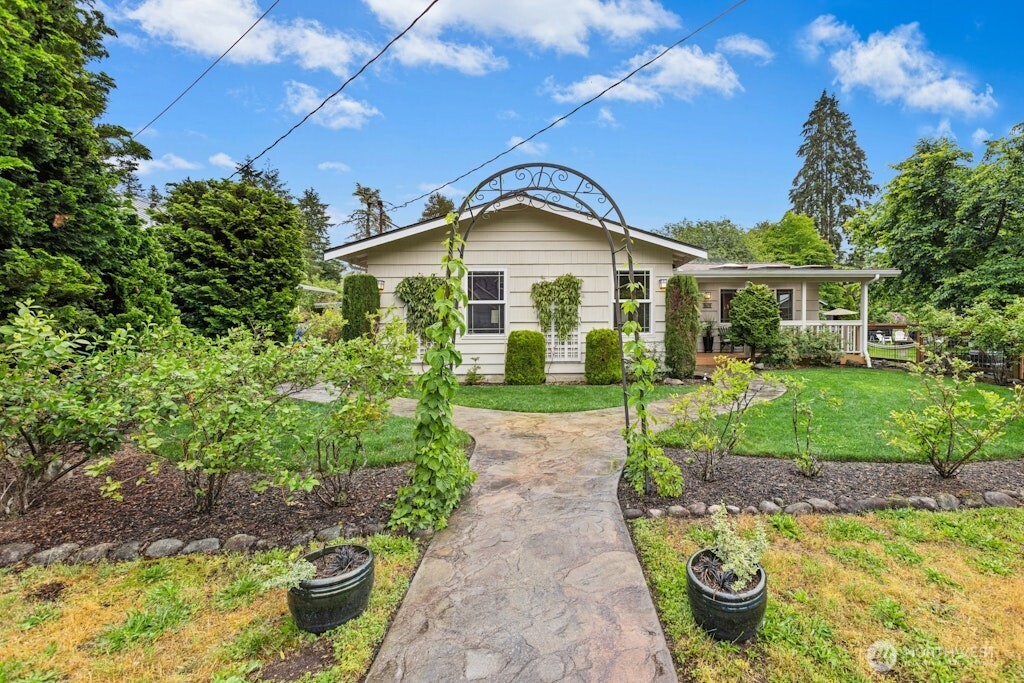 Stamped concrete walkways and lush gardens welcome you to this rambler on a dead end street.