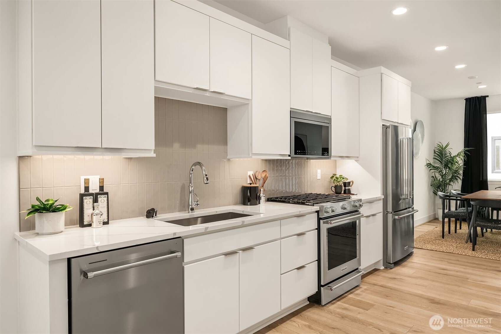 Beautifully appointed kitchen with walk-in pantry flows into open-concept living spaces