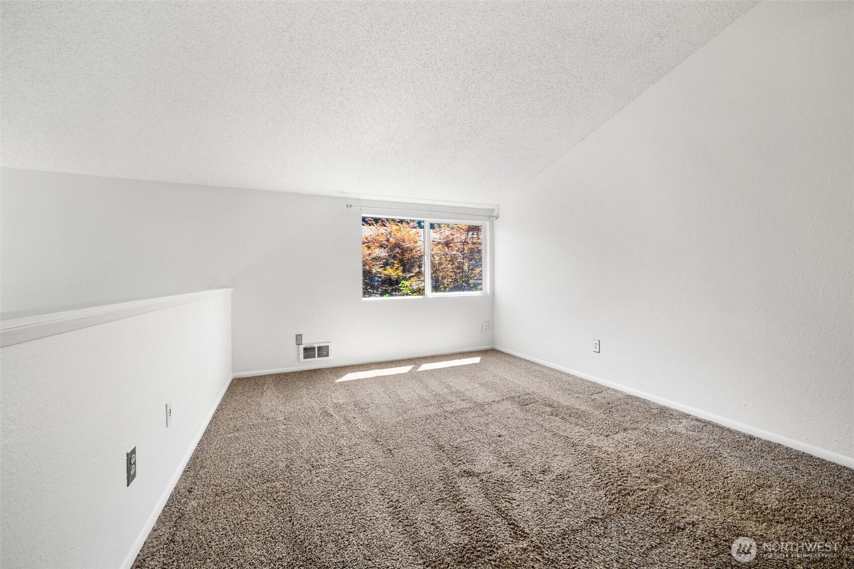 Primary bedroom flooded with natural light and features a walk in closet and 3/4 en suite bathroom.