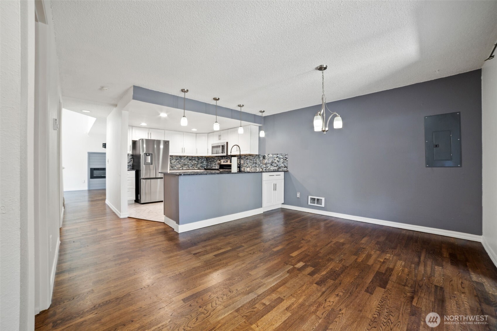 Upon entry greeted with hardwood flooring into the formal dining area and kitchen. There is a second fenced in patio to the right of the dining area.