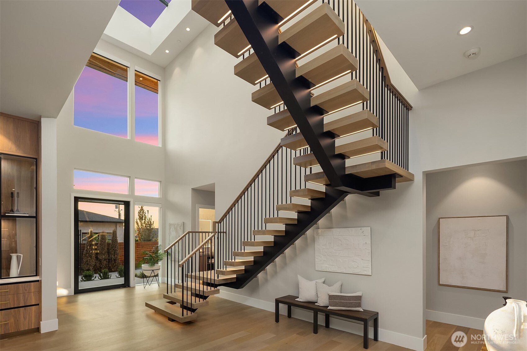 Entryway featuring open mono stringer stairs & a custom 10 panel skylight