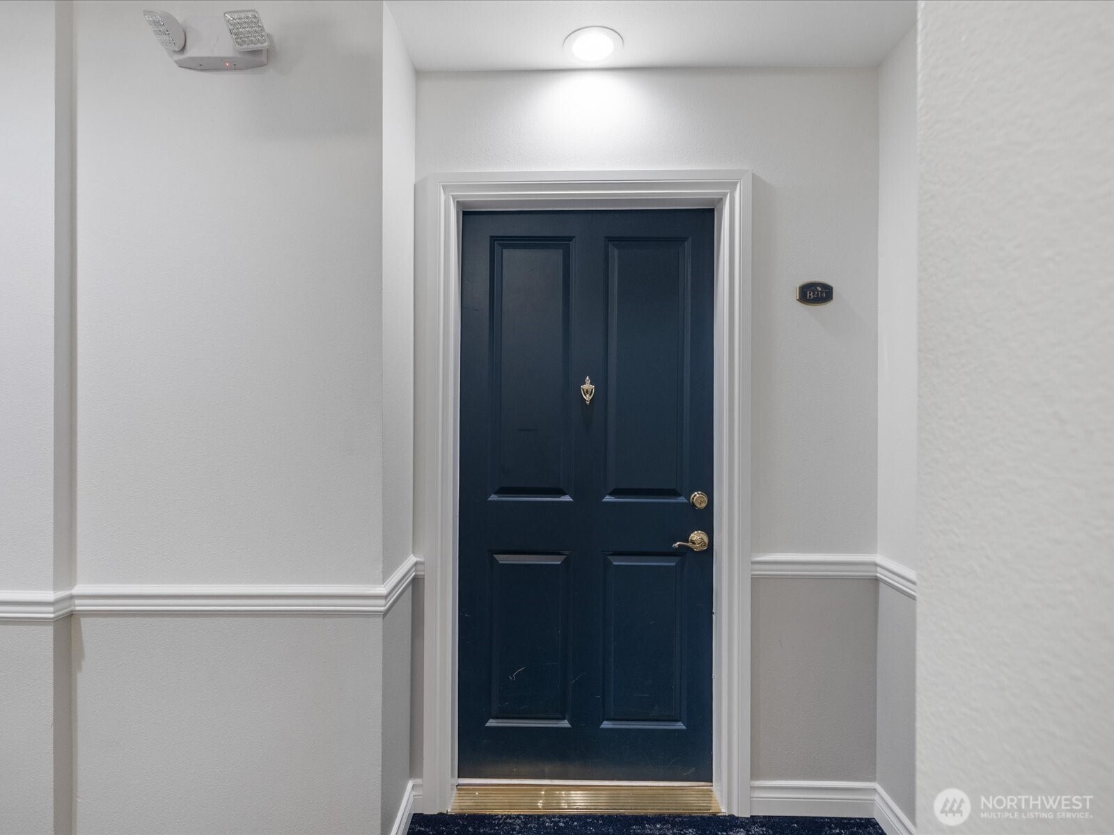 Interior entry with secure building access, controlled lobby entry, and defined hallway leading into unit living spaces.