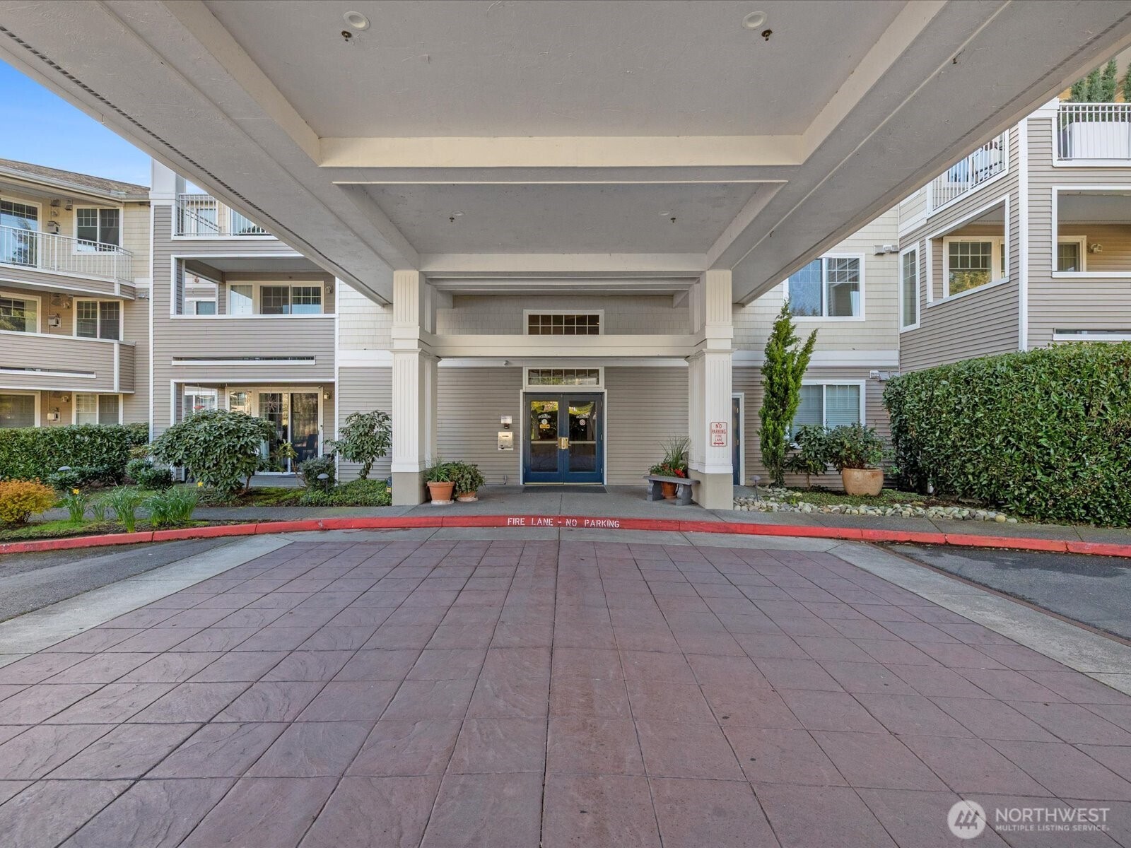 Covered building entrance with drive-up access for loading and unloading, located at the main lobby entry.