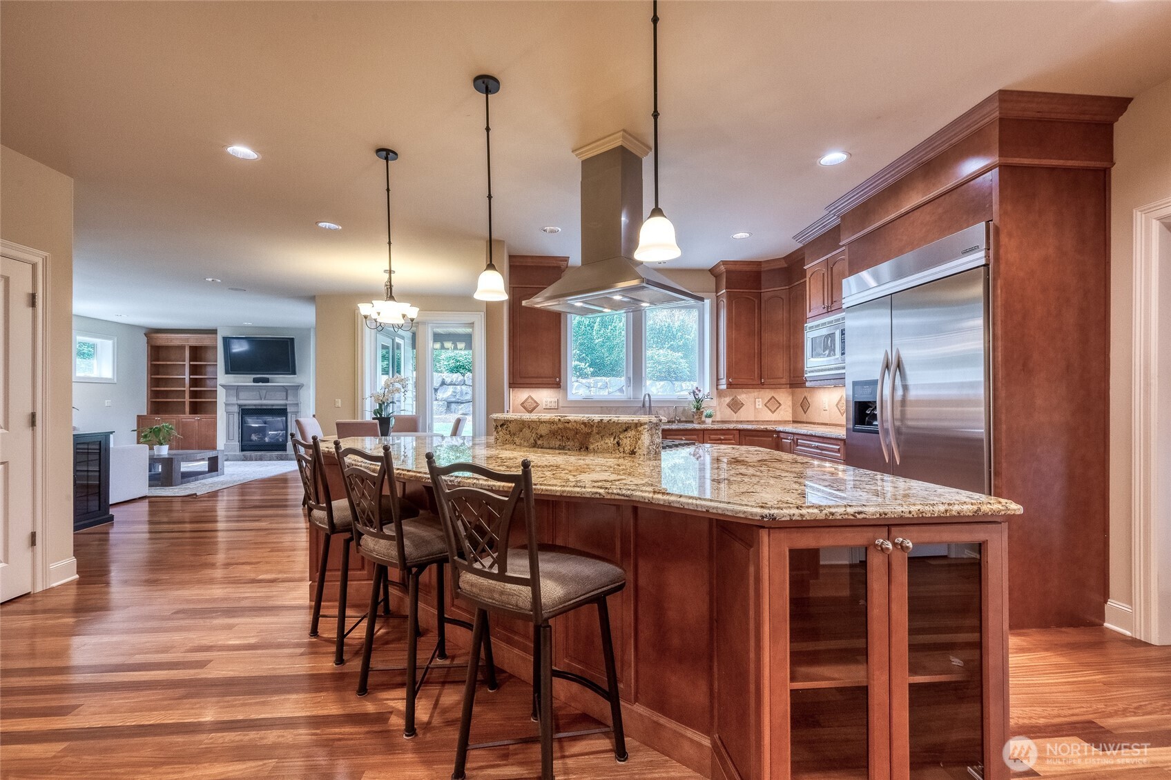An impressive open-concept chef’s kitchen serves as the heart of the home.