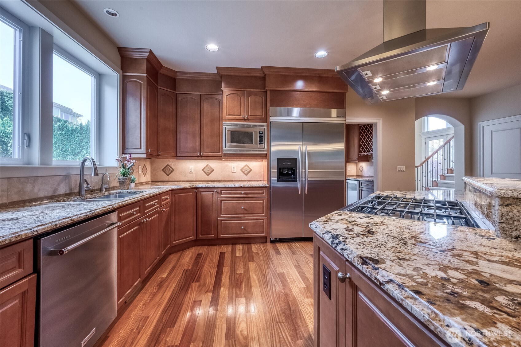 Exceptional custom cabinetry with soft-close drawers and premium finishes reflects superior craftsmanship and thoughtful design throughout the kitchen.