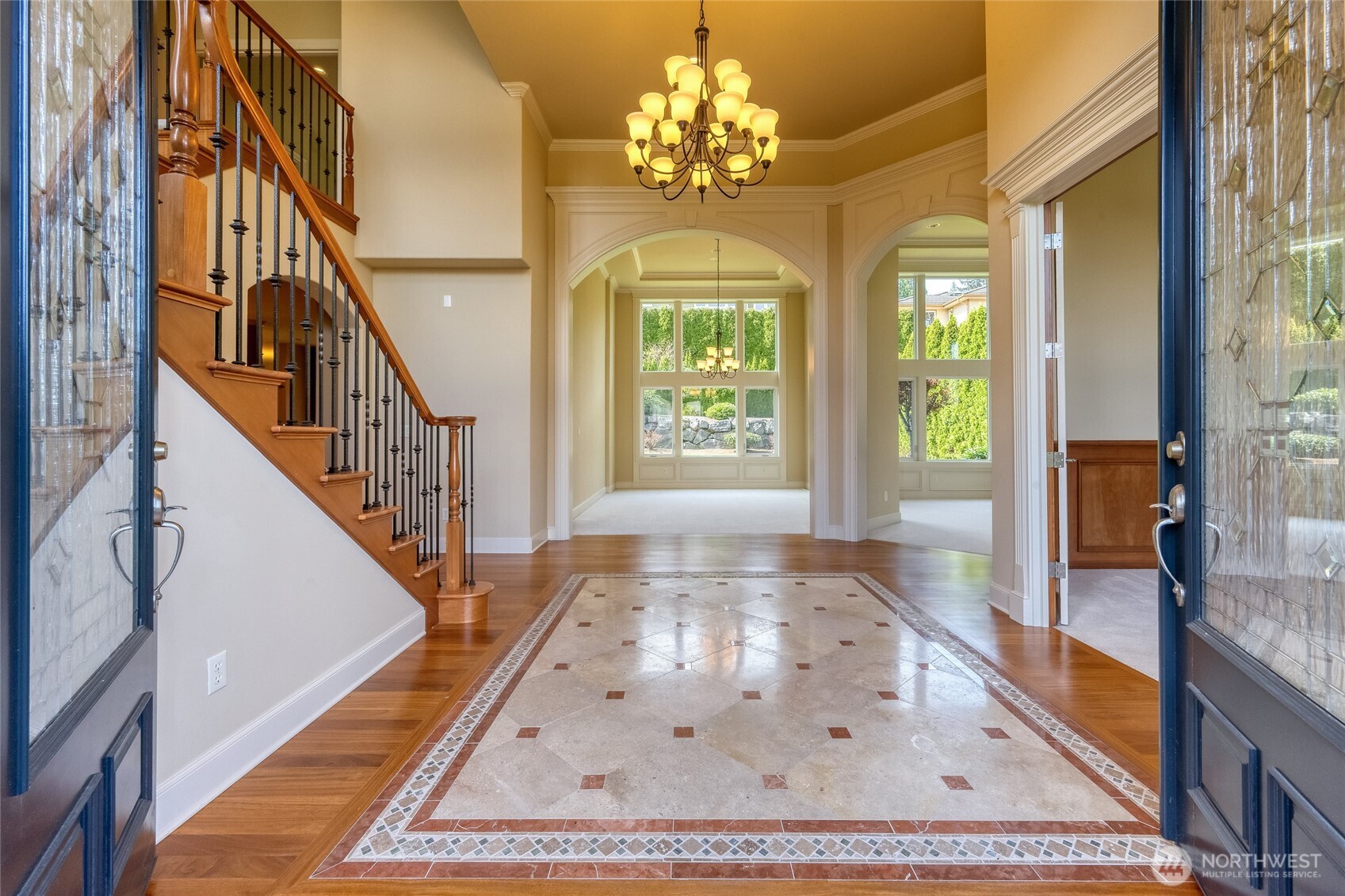 Elegant grand entry foyer with marble-inlaid floors.