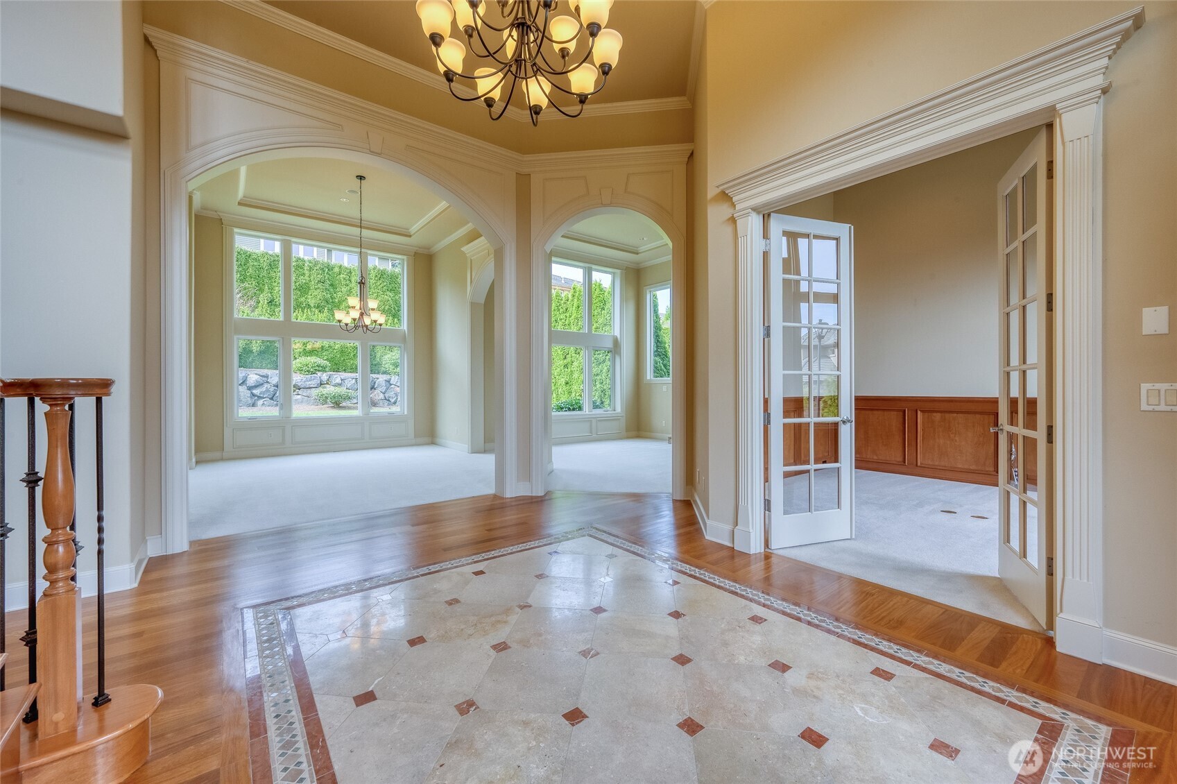 A den/library just off the entry offers beautiful wood wainscoting, adding warmth, charm, and functionality.
