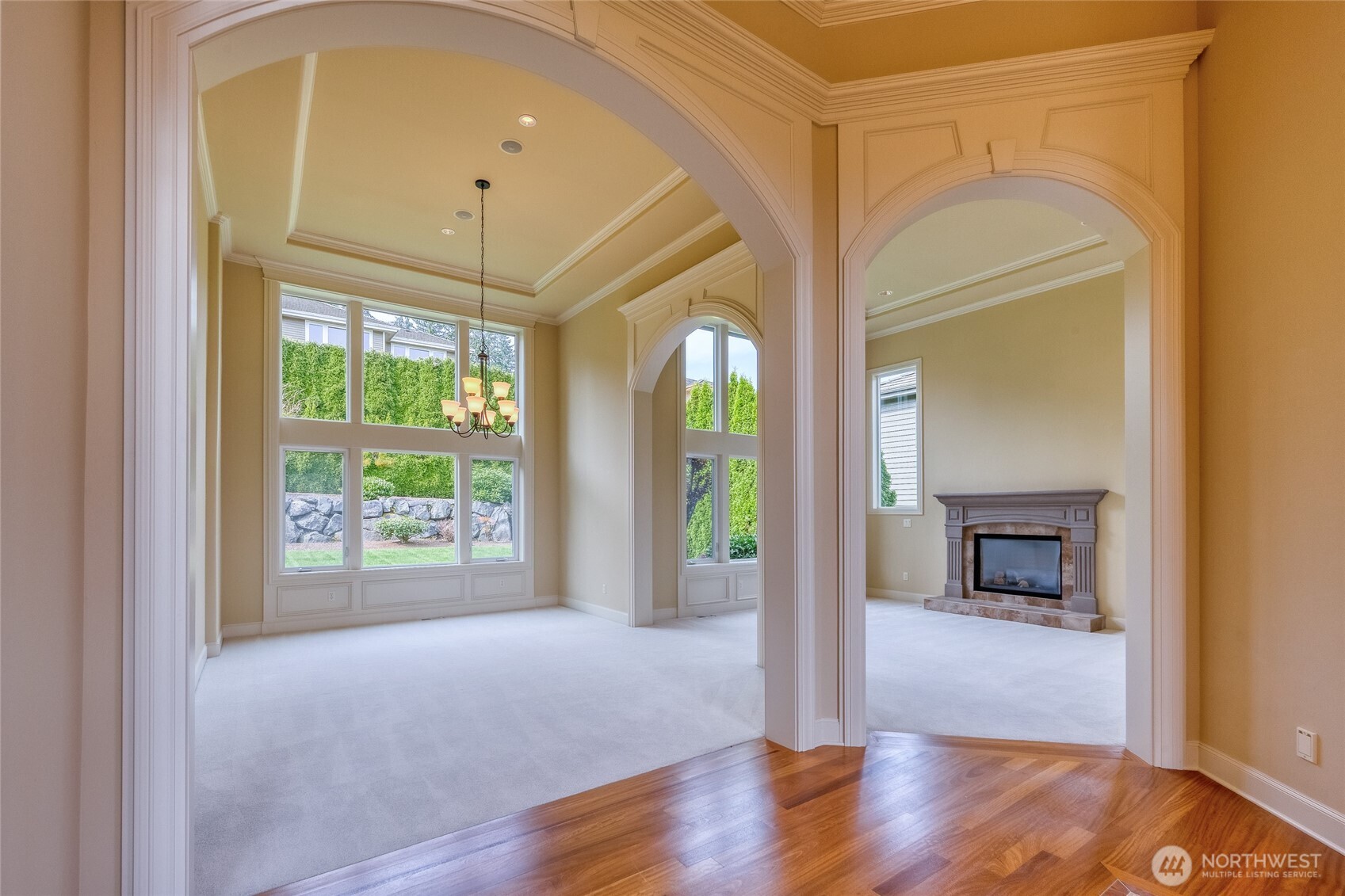 Soaring ceilings, custom millwork, and abundant natural light combine to create an elegant, open, and airy living environment throughout the home.