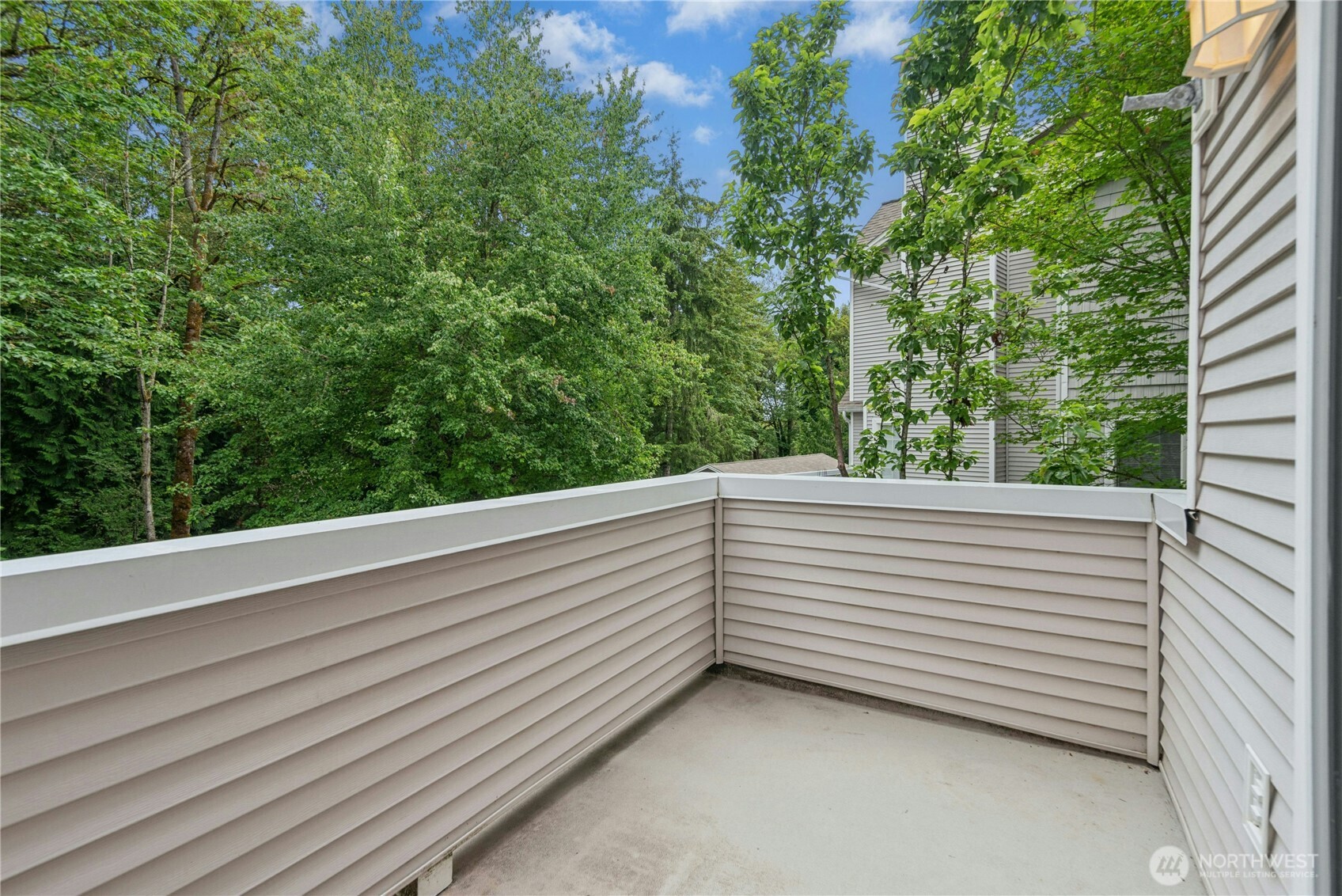 Alternate view of the rear deck with peaceful views of the surrounding trees.