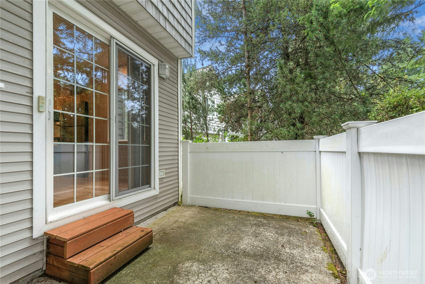 Breakfast nook opens directly to the private rear deck through a sliding glass door, making indoor and outdoor living easy.
