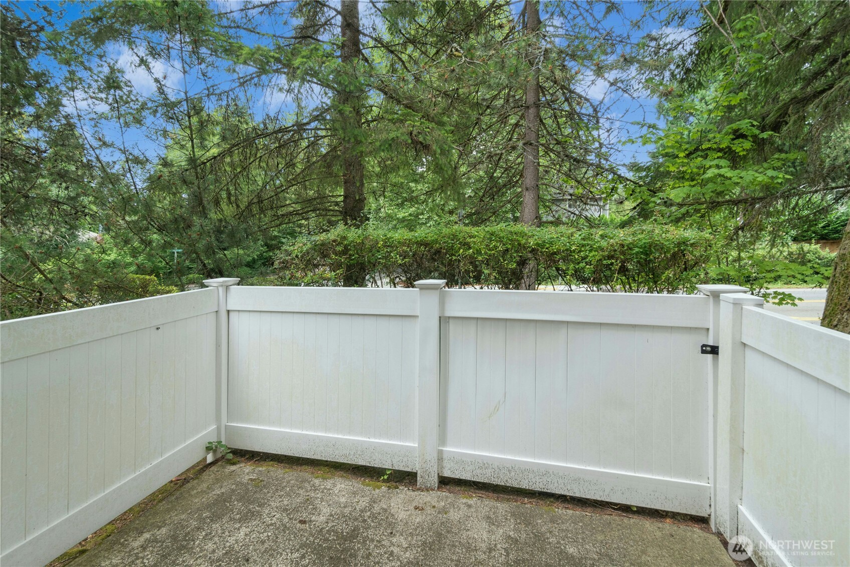 Alternate view of the private rear deck overlooking a peaceful treed setting.