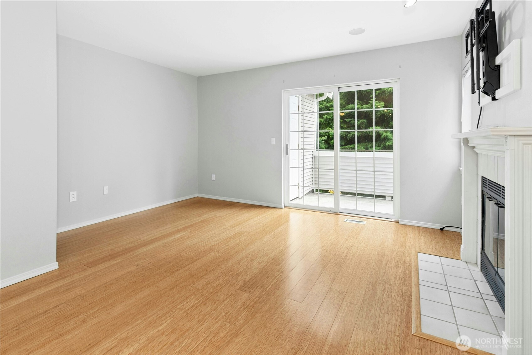 Living room with gas fireplace and open layout connecting to the dining area and kitchen.