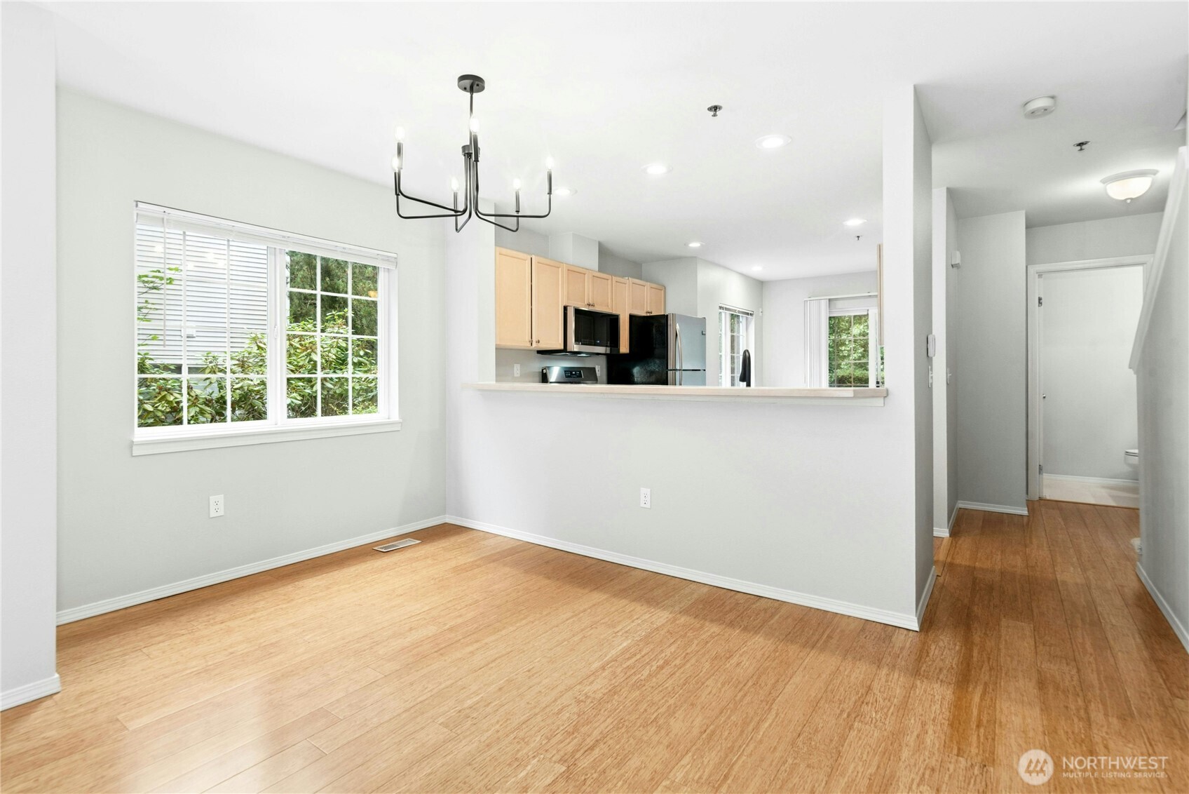 Dining area opens to the kitchen and living room, creating a functional layout for everyday living and entertaining.