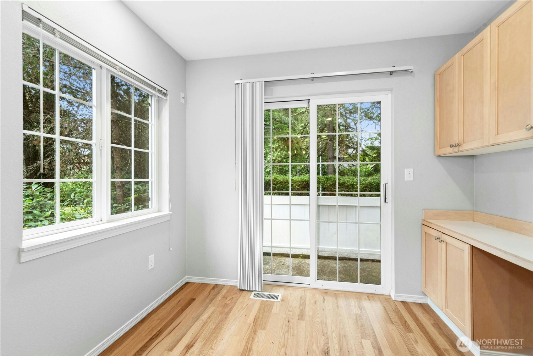 Breakfast nook with sliding glass door providing direct access to the private rear deck.