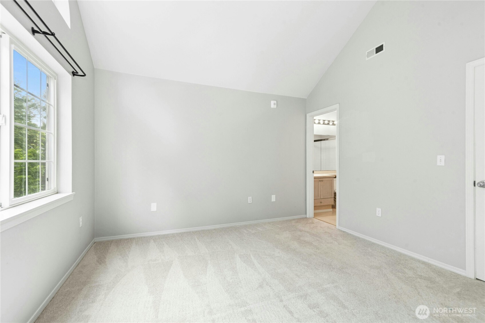 Alternate view of the spacious primary bedroom with ensuite bath and walk-in closet.