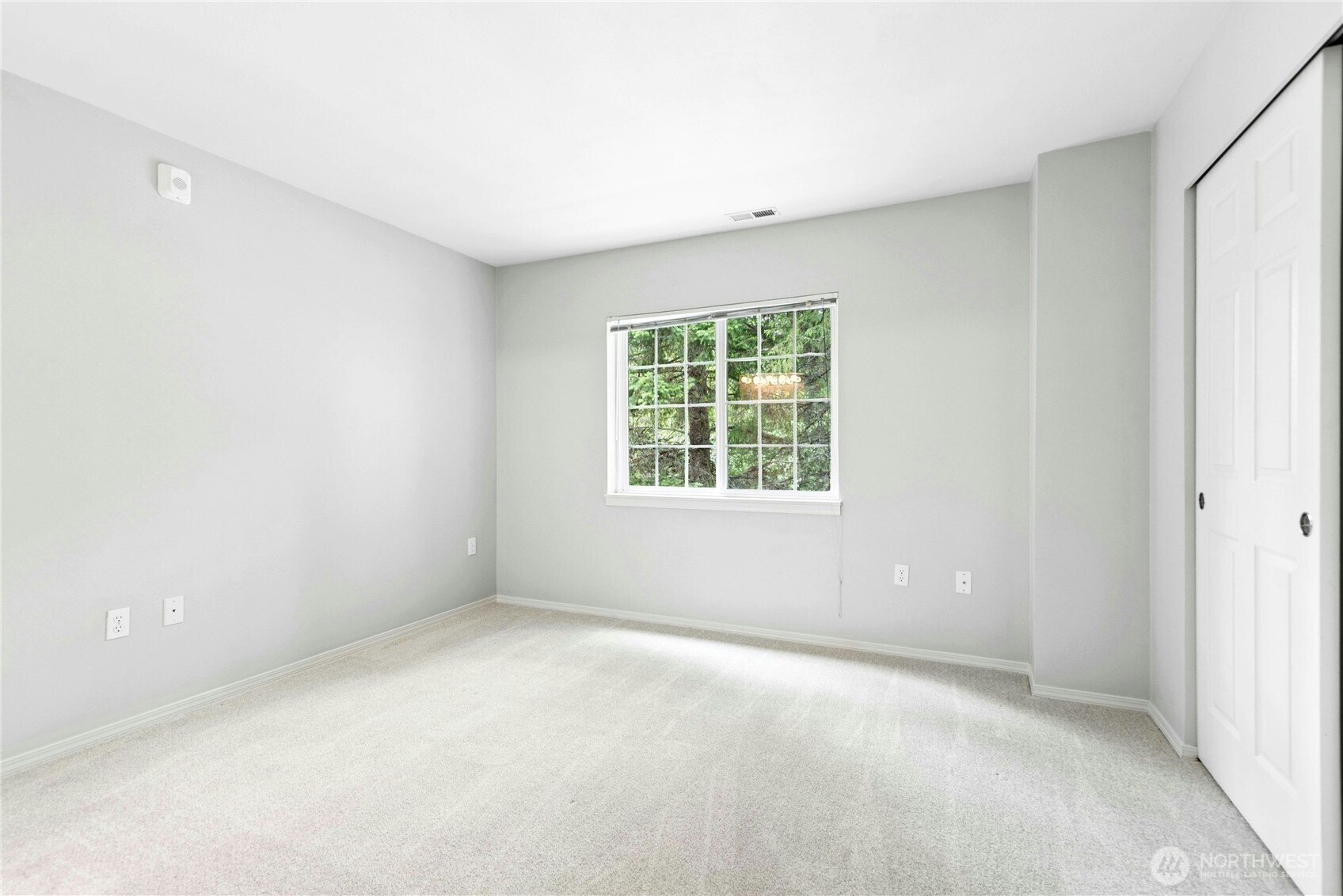 Second bedroom with large window and generous closet space.