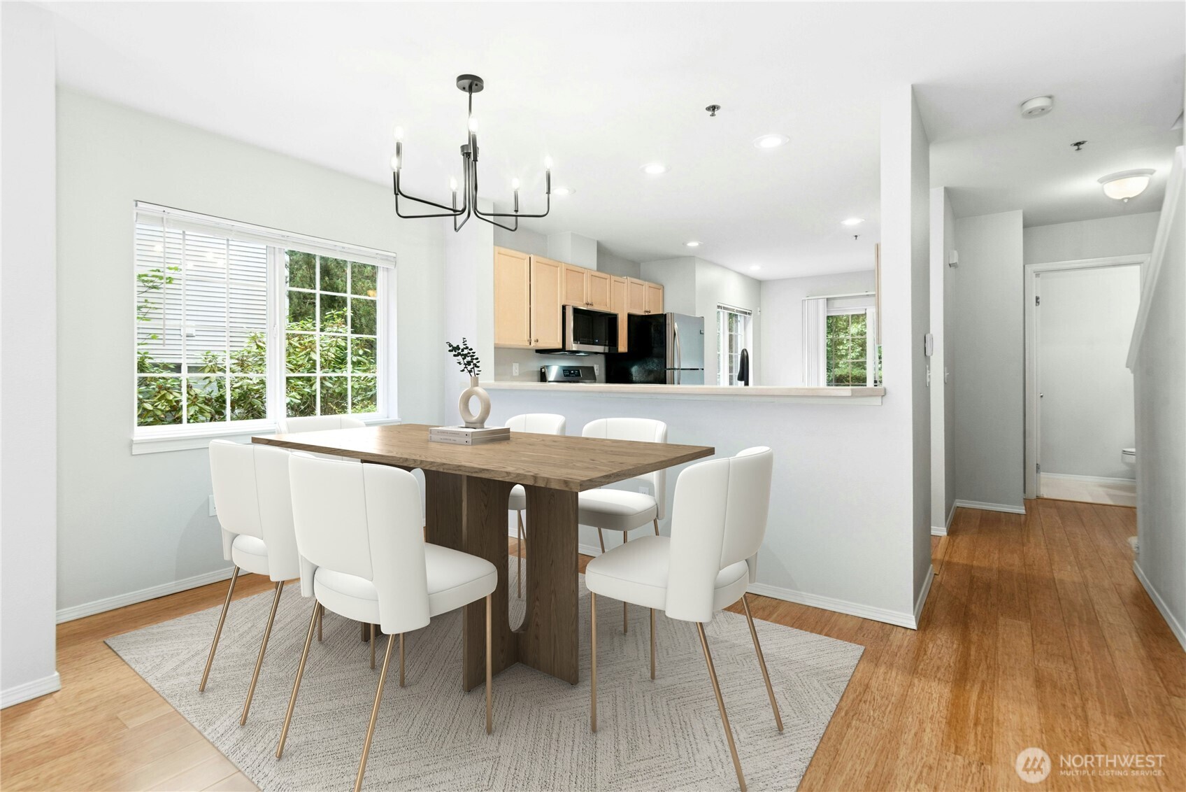 Virtually Staged - Open dining area with seamless flow between the kitchen and living room.