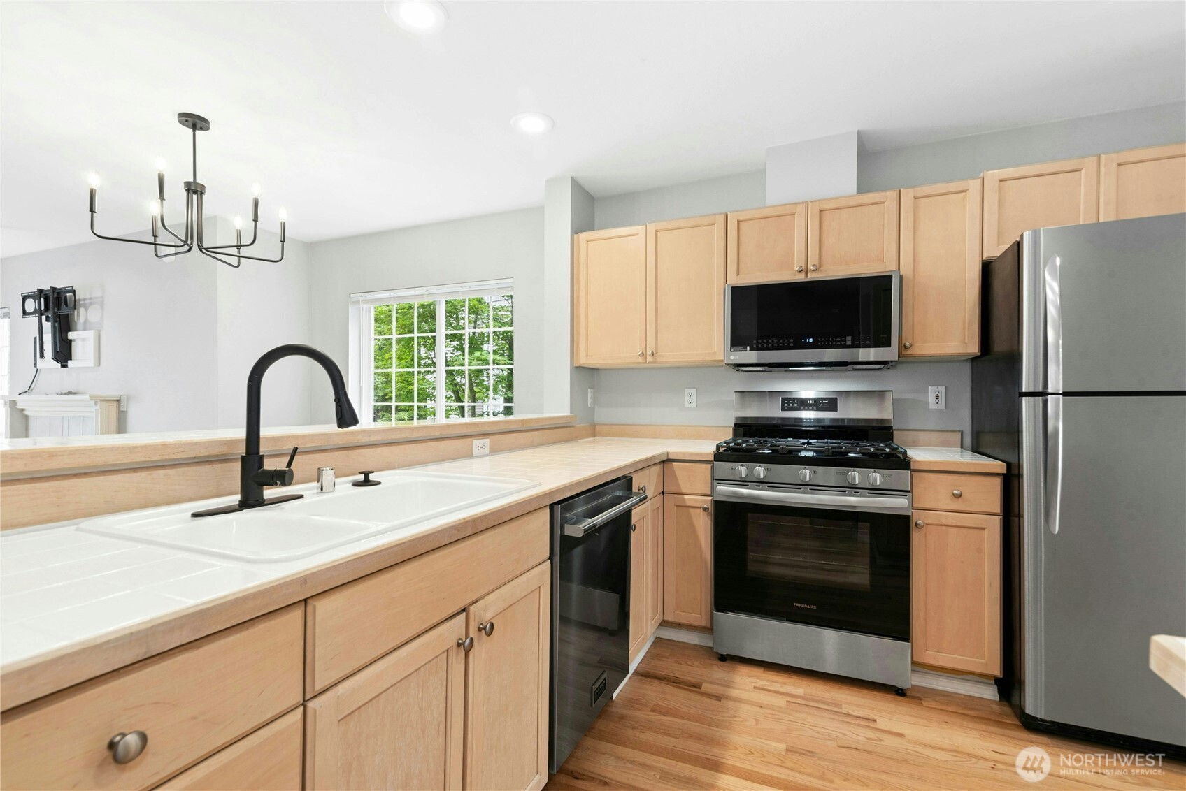 Kitchen featuring stainless steel appliances, abundant cabinet and counter space, and breakfast bar seating.