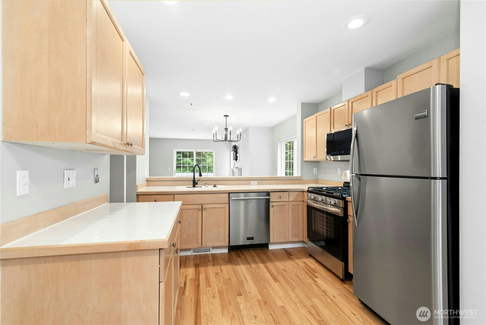 Functional kitchen with stainless steel appliances, generous workspace, and an open layout.