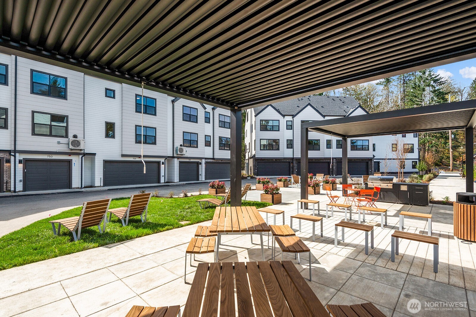 Outdoor community area! Featuring picnic tables, benches, loungers, fire bits, BBQ and, ping pong table.