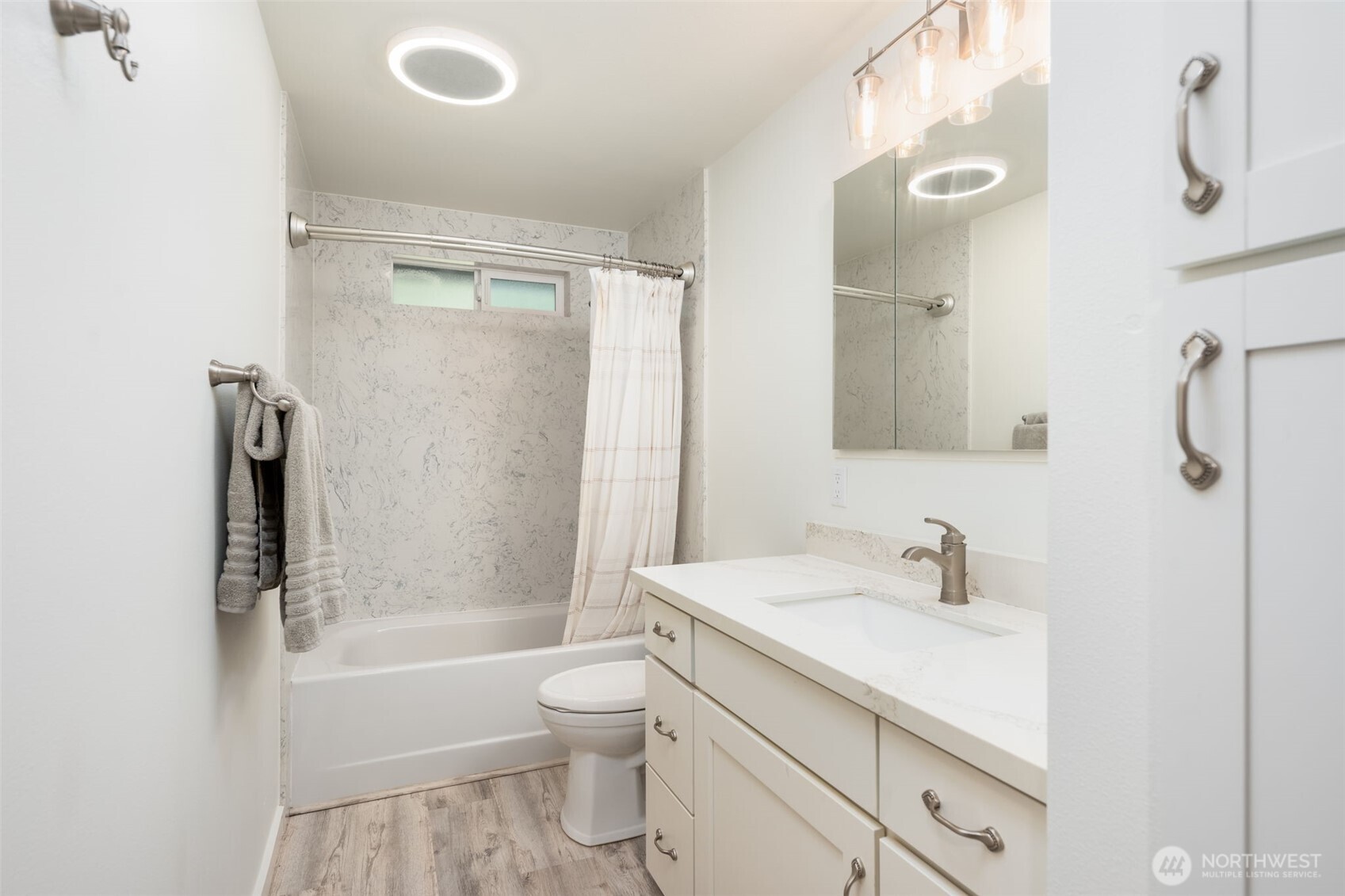 The remodeled main bathroom is just off the hallway.