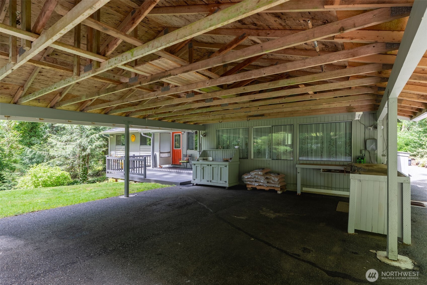 Large two car carport with built in work bench has room for everything!