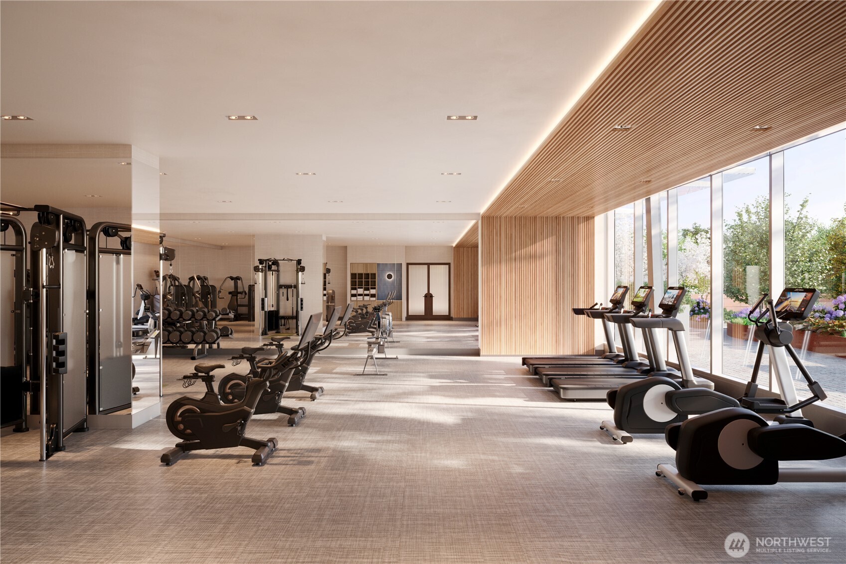 Fully equipped fitness facility with expansive windows, cardio equipment with TVs, free weights, multi-gym system, towel service and water station.
