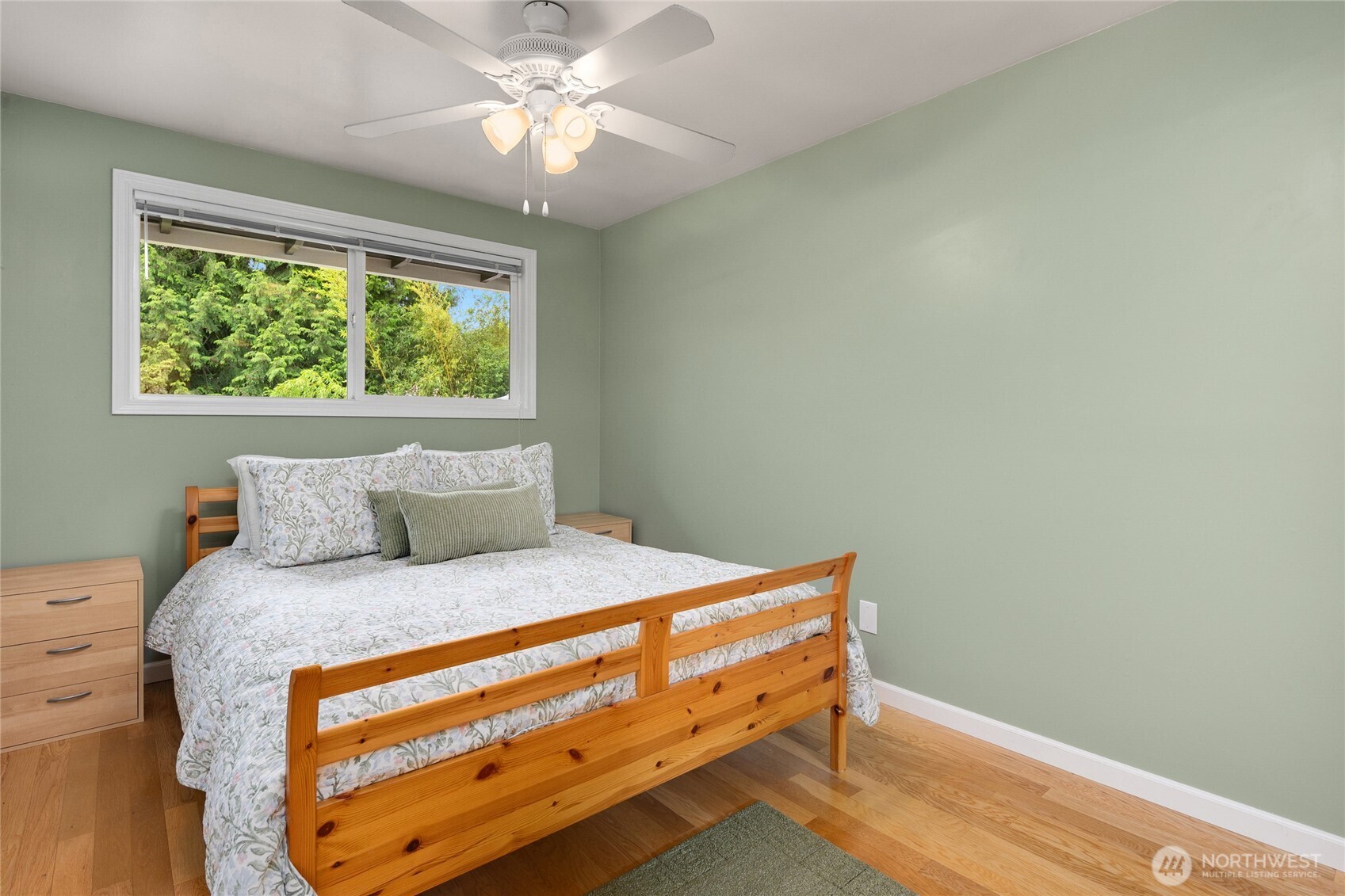 The 3rd upper level bedroom also features hardwood floors and a ceiling fan.