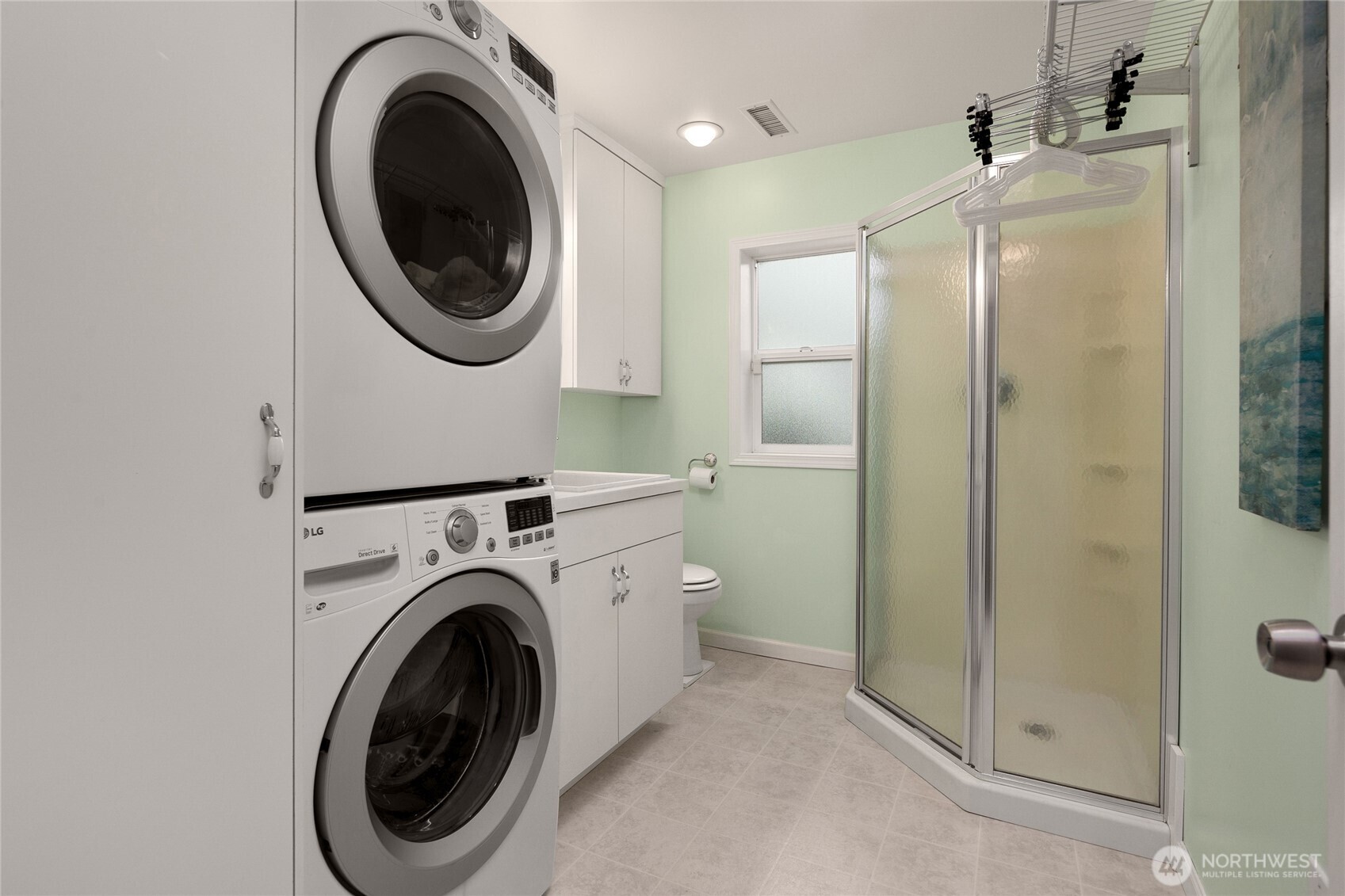 Lower level 3/4 bath with utility sink and washer/dryer (included)