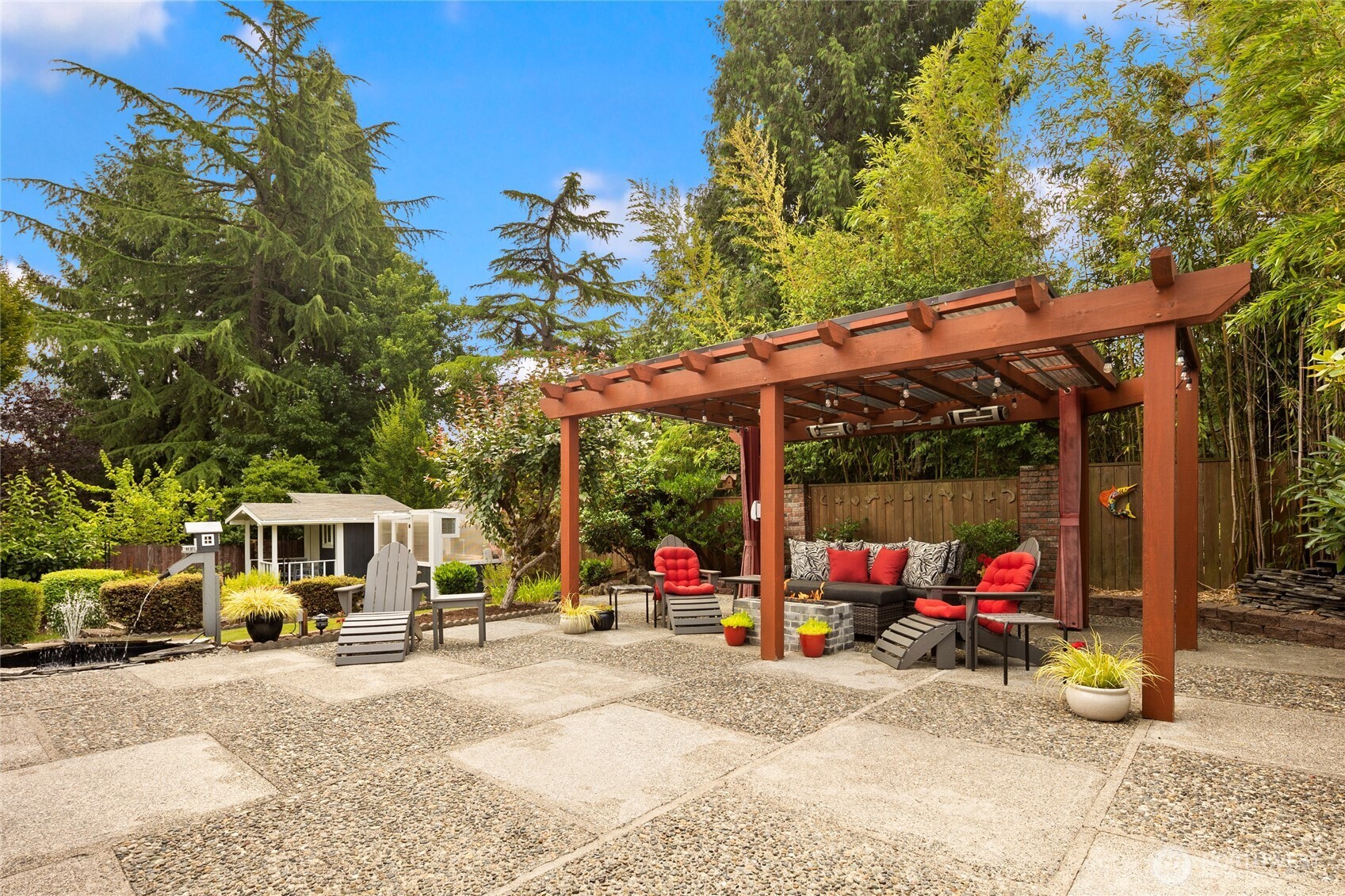 Notice the water feature to the left of the photo. The outbuilding that matches the home can also be seen here.