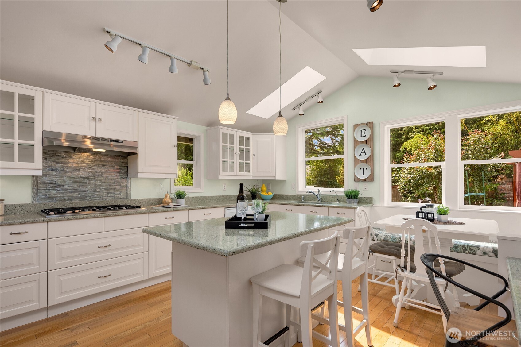 Notice the large windows & skylights that bring in so much natural light. The view of the backyard from the kitchen sink is so beautiful!