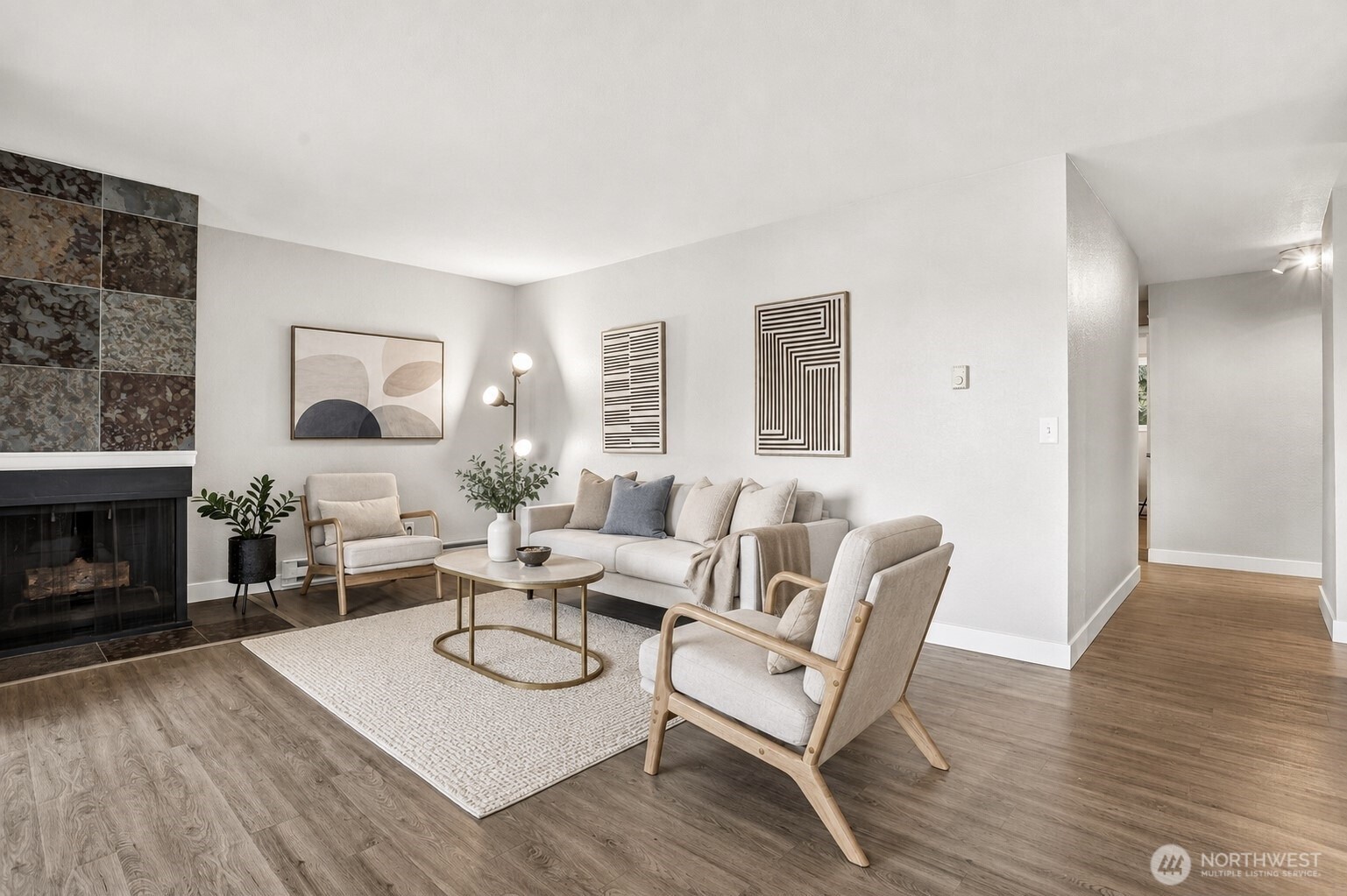Virtually Staged another view of living room, Nicely neutral paint and a fireplace brings warmth and a great flow throughout!