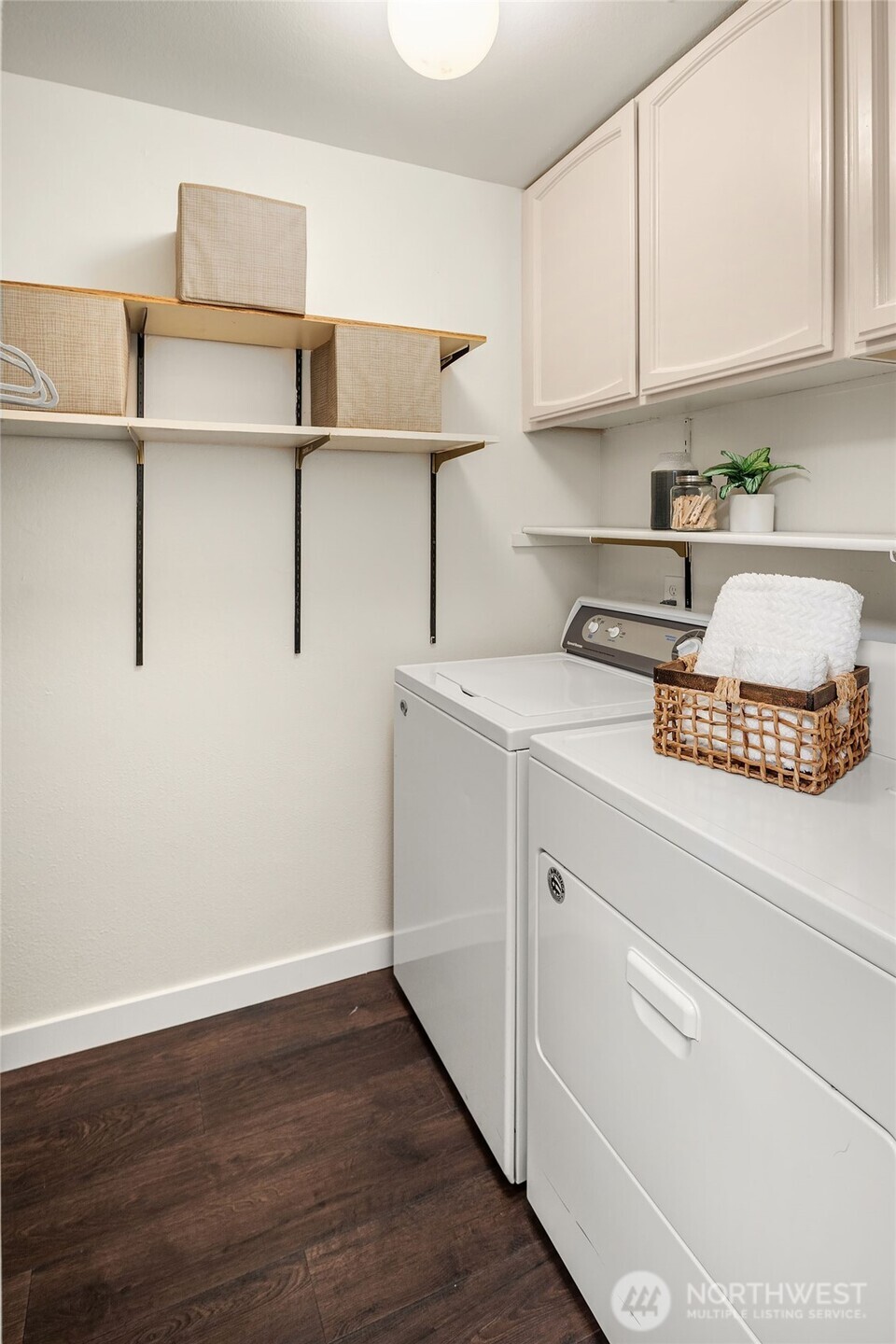 Laundry room with full sized washer & dryer and extra storage.