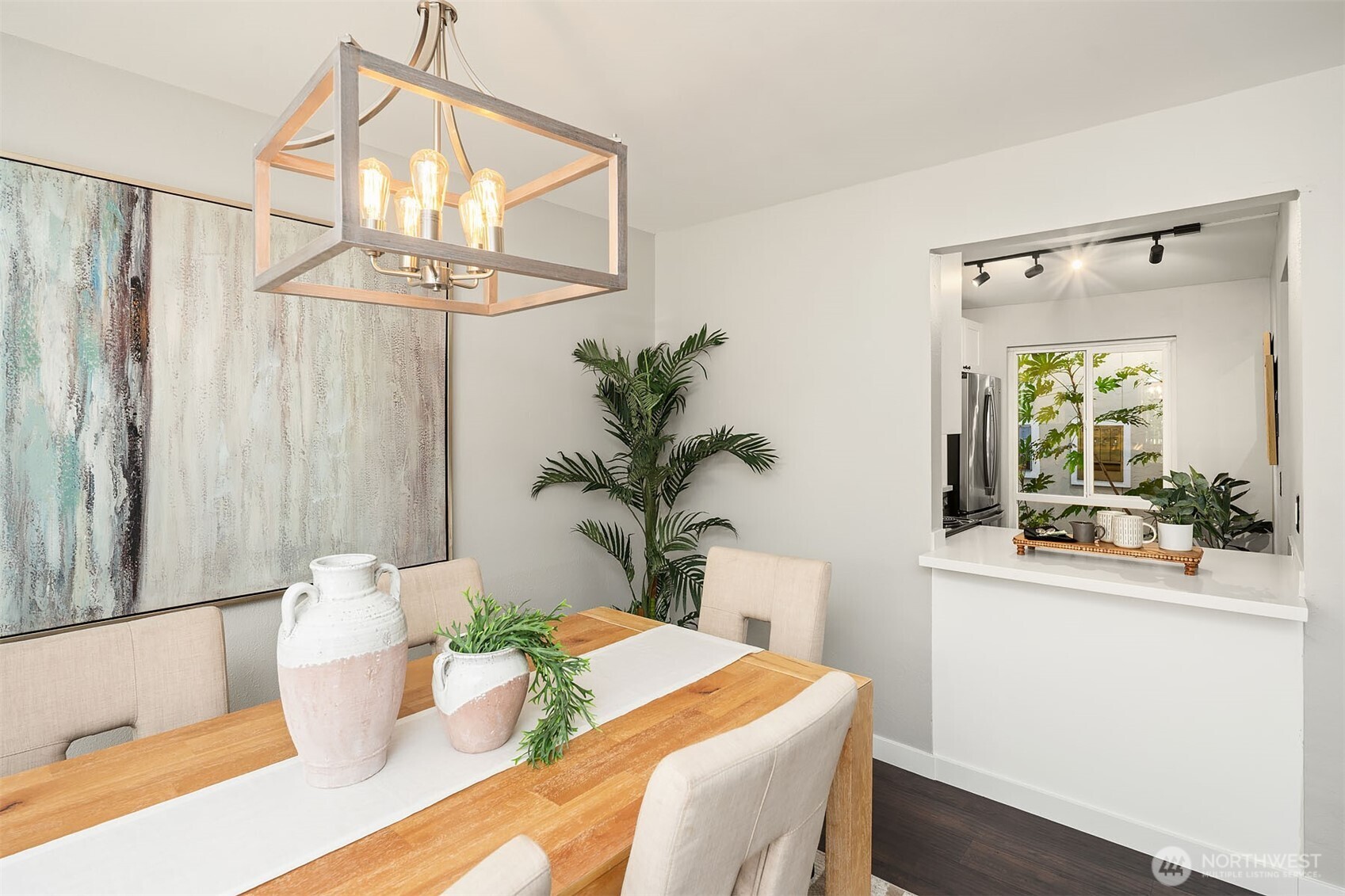 Updated lighting above dining room table! Easy pass through window from kitchen.