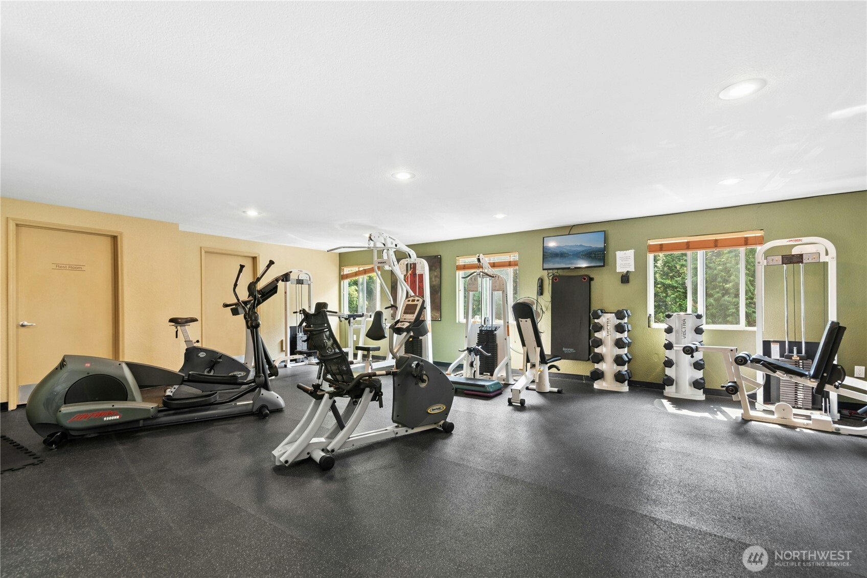 Huge fitness center with an abundance of natural light.