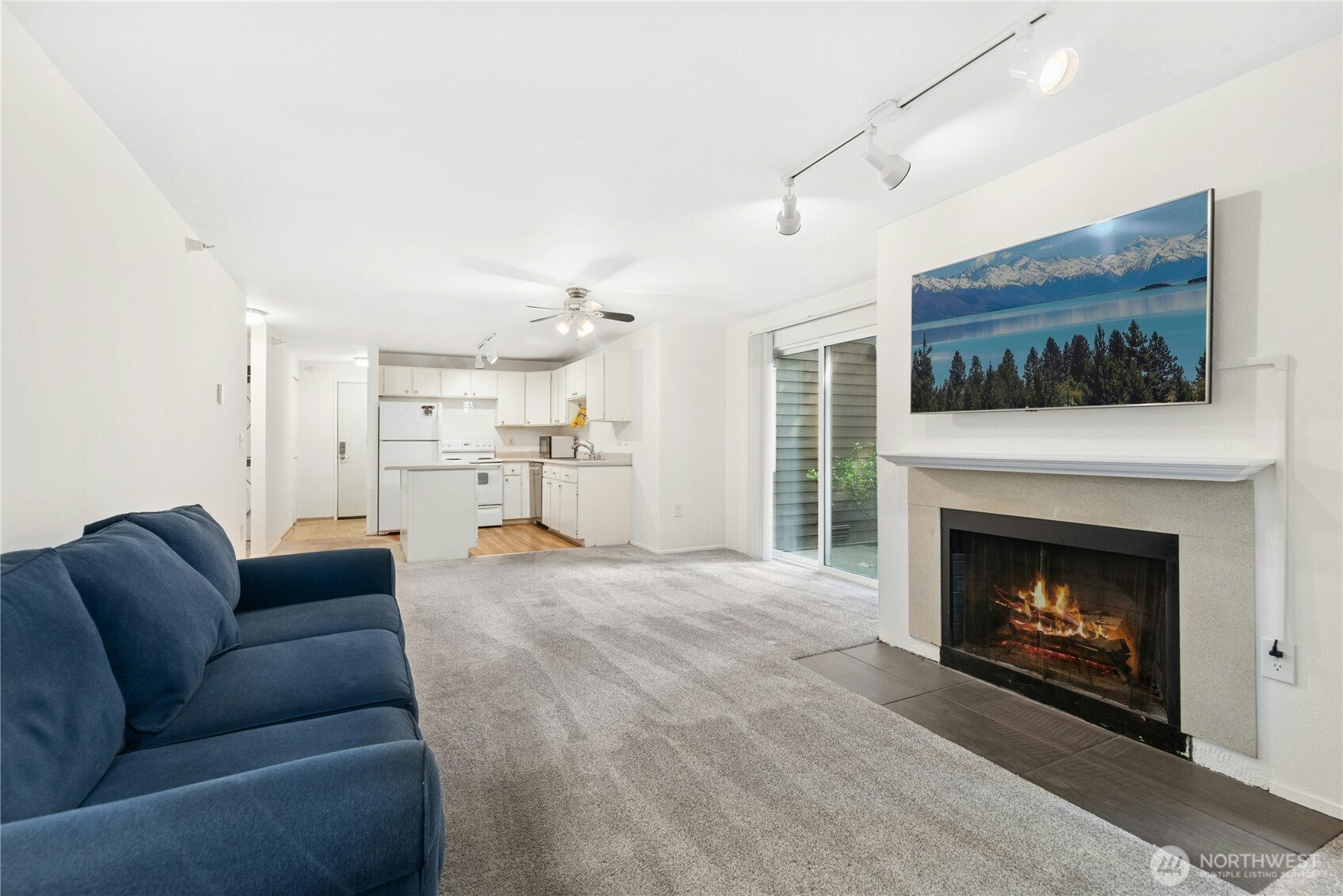 Large open concept living with wood burning fireplace.