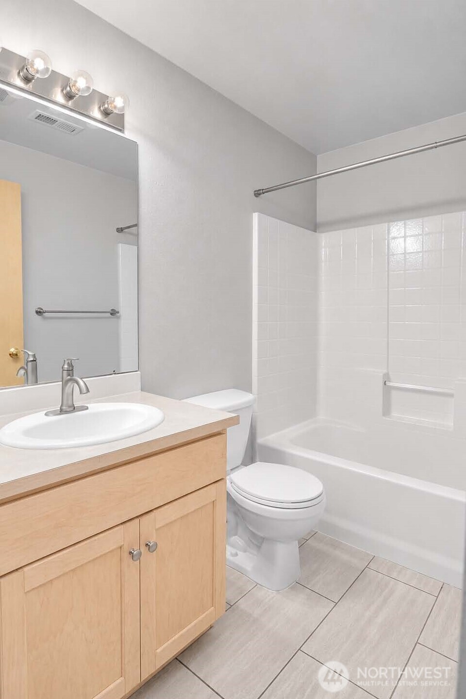 Separate Laundry-Mud room. Paneled Quaker door. Premium Plank “Dora Walnut” floor. Maytag® washer (2024). Samsung® dryer (2022). Wall-to-wall shelf and white storage cabinets above washer and dryer. Clothes-hanging bar and shelving. Window with pulldown shade.
