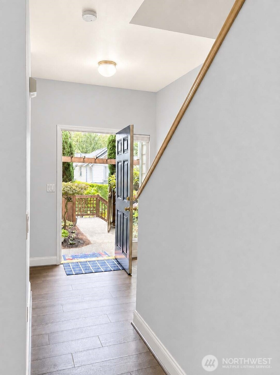 Entry interior. Premium Plank “Dora Walnut” flooring throughout the main level (2020). High 9-ft ceilings throughout main level. Entry area with 9-ft high ceiling. App-controlled Nest® Smart thermostat.