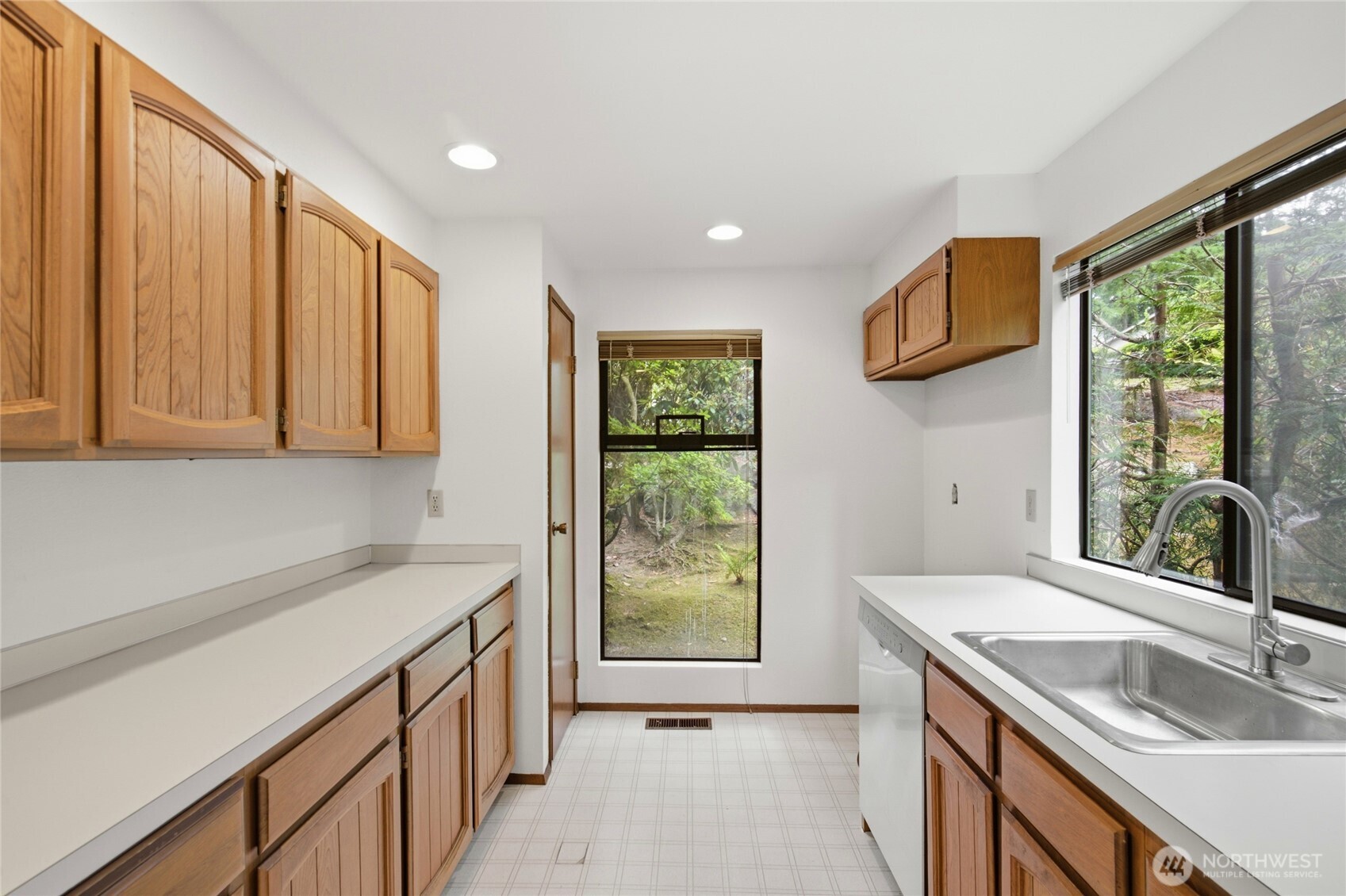 Kitchen with abundant cabinetry and a window outlook.