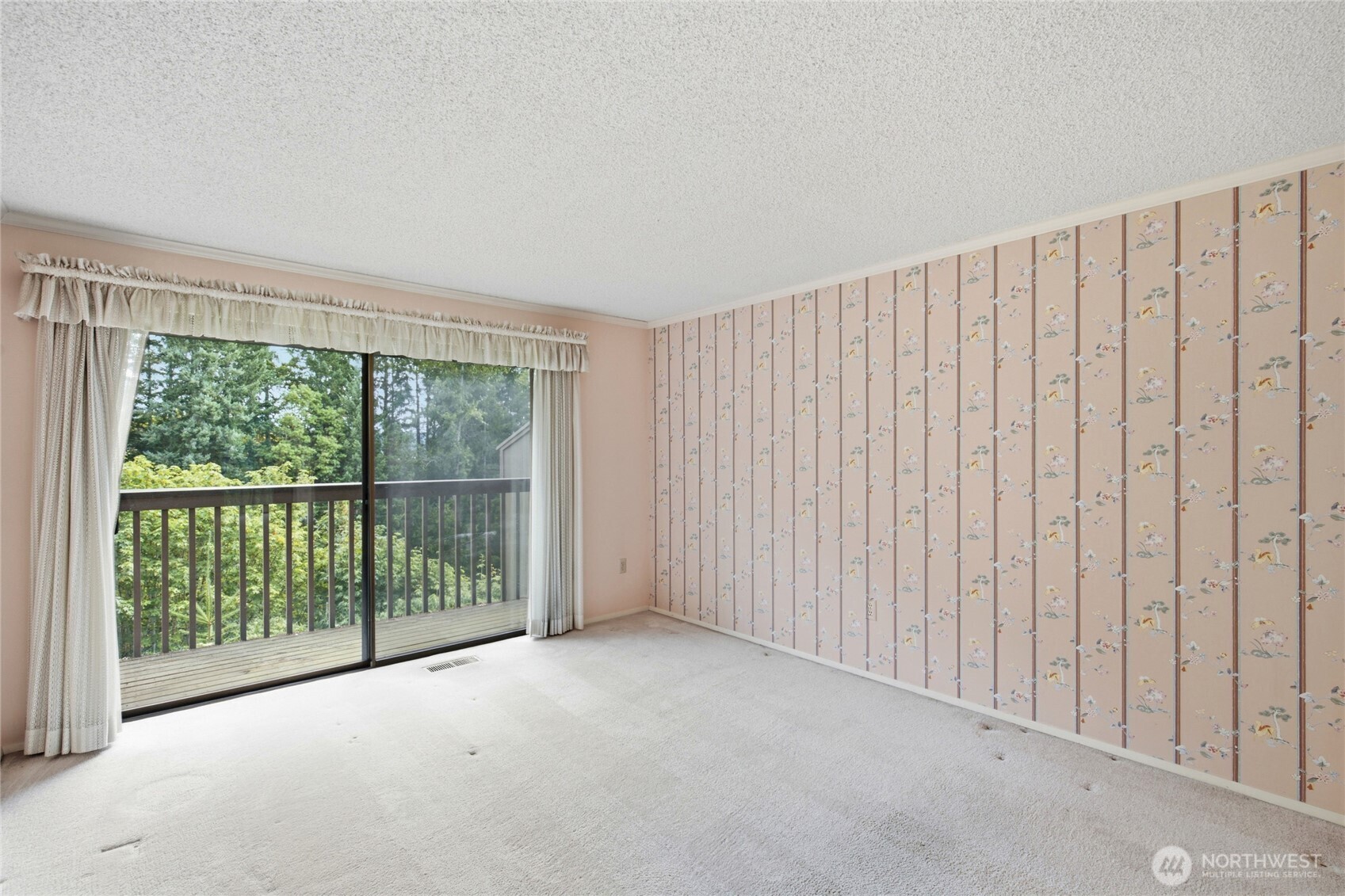 Light filled room opening to the deck and greenbelt.
