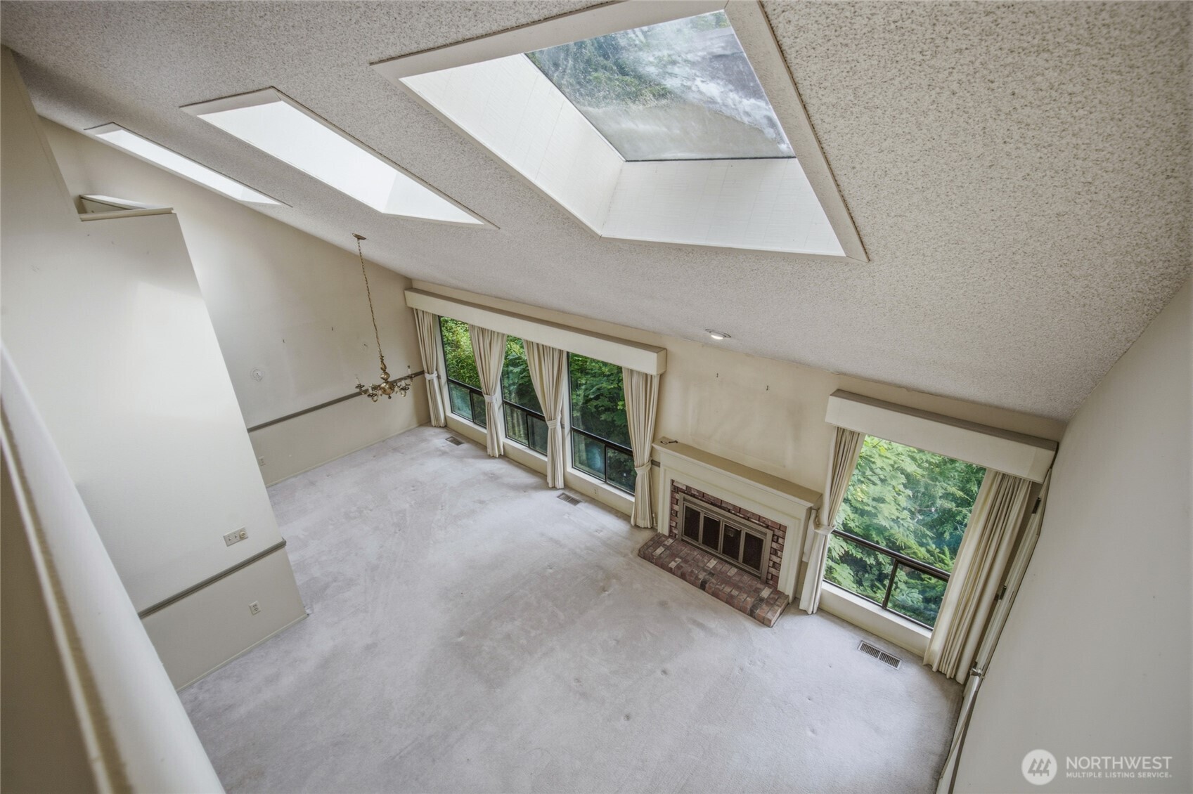Skylights and vaulted ceilings carry light through the upper level.