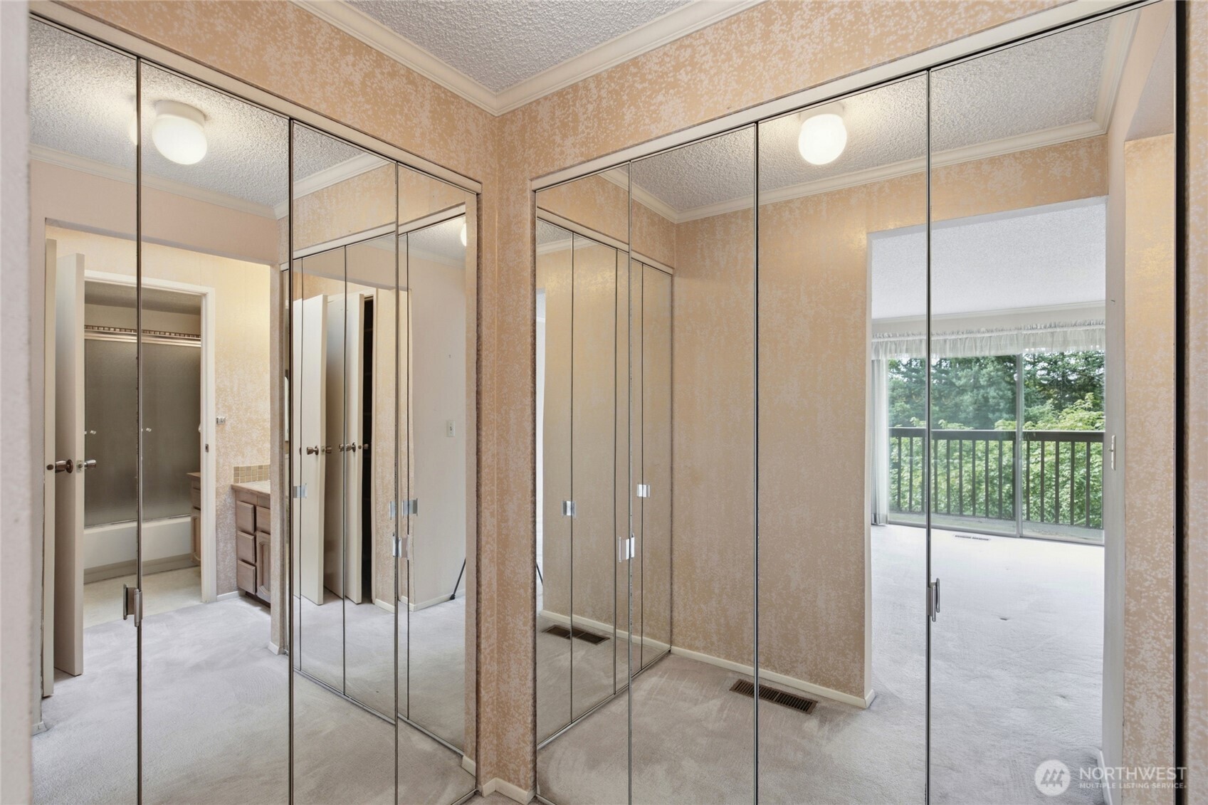 Mirrored wardrobe wall, room to reimagine.