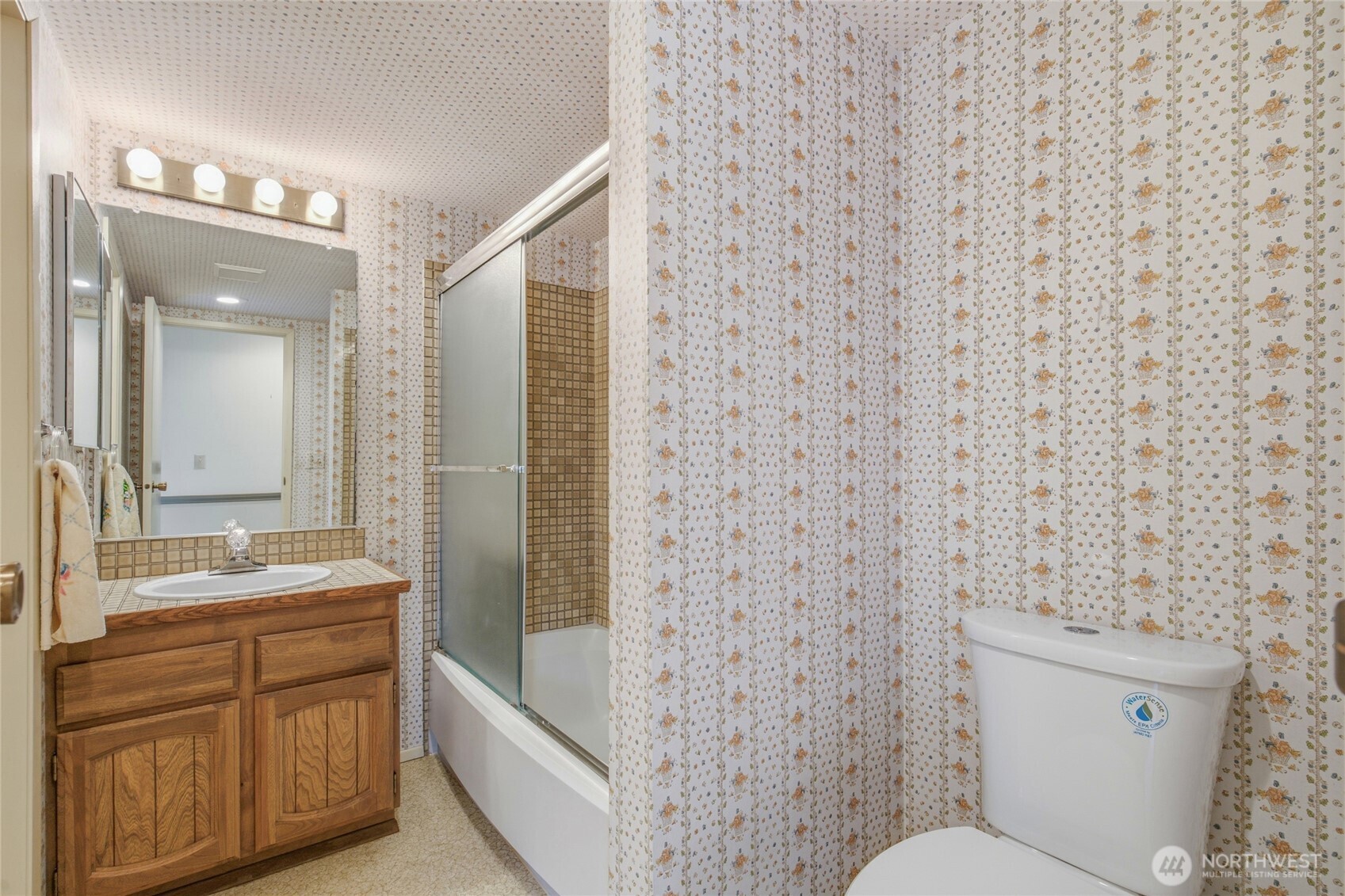 Full bath with vanity and tub shower.