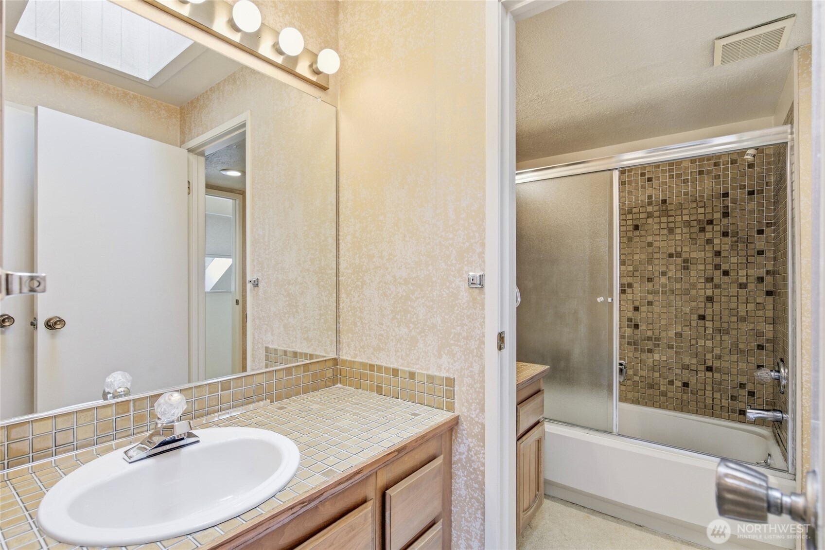 Bath with soaking tub and generous counter space.