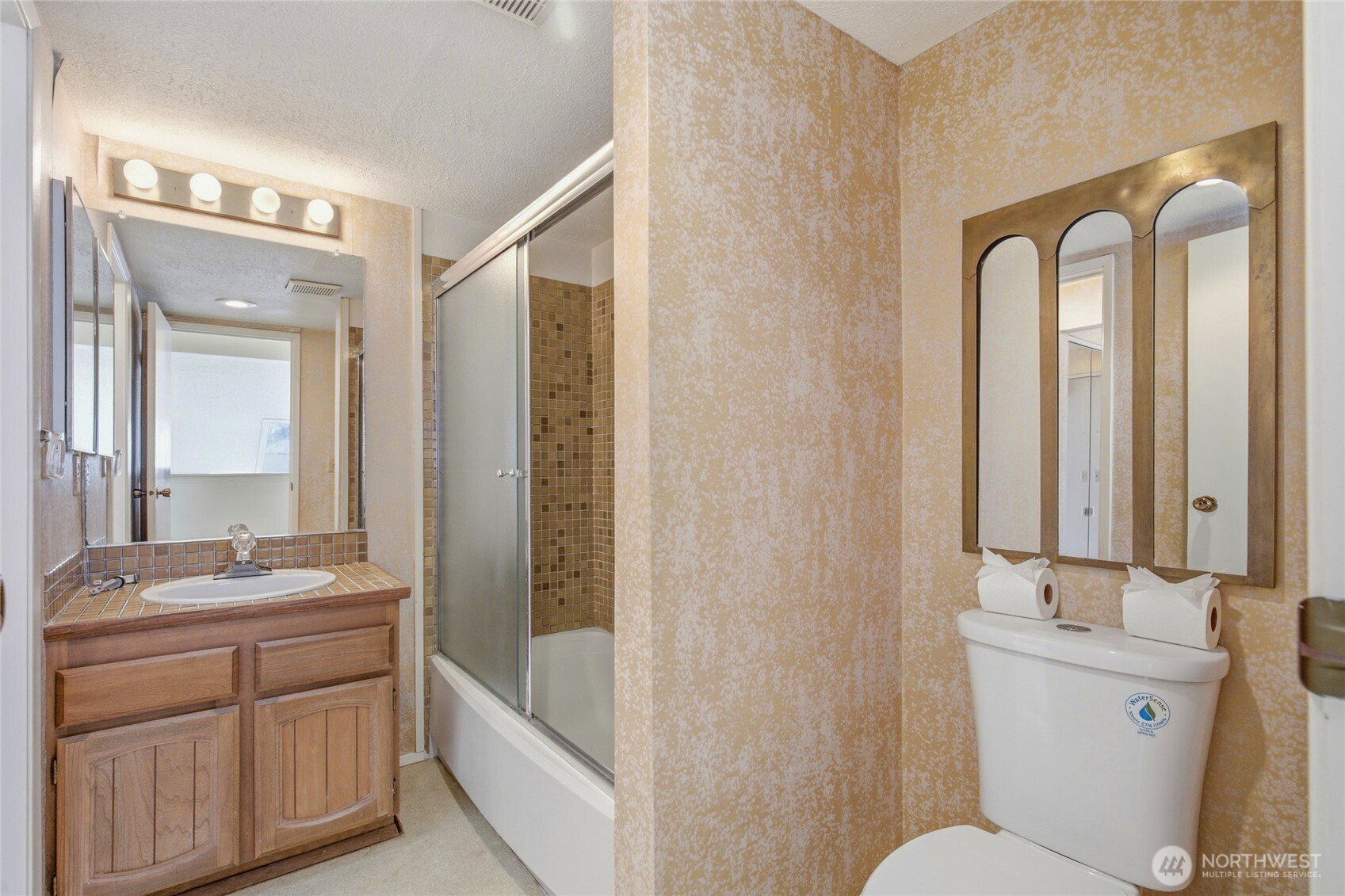 Second bath with wood vanity.