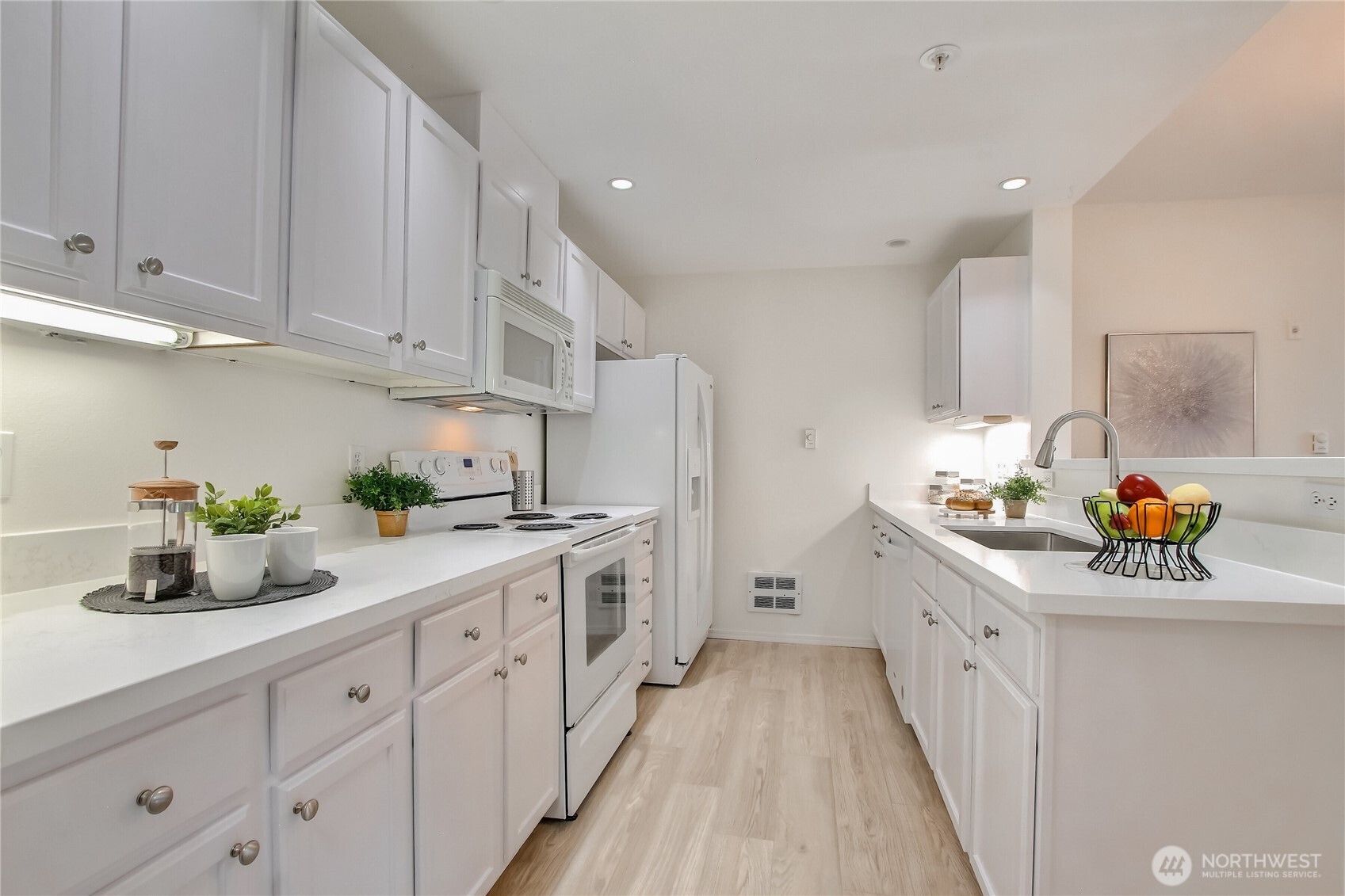 Fresh kitchen with new Granite countertops, hardware, waterproof laminate floors, and freshly painted cabinets.