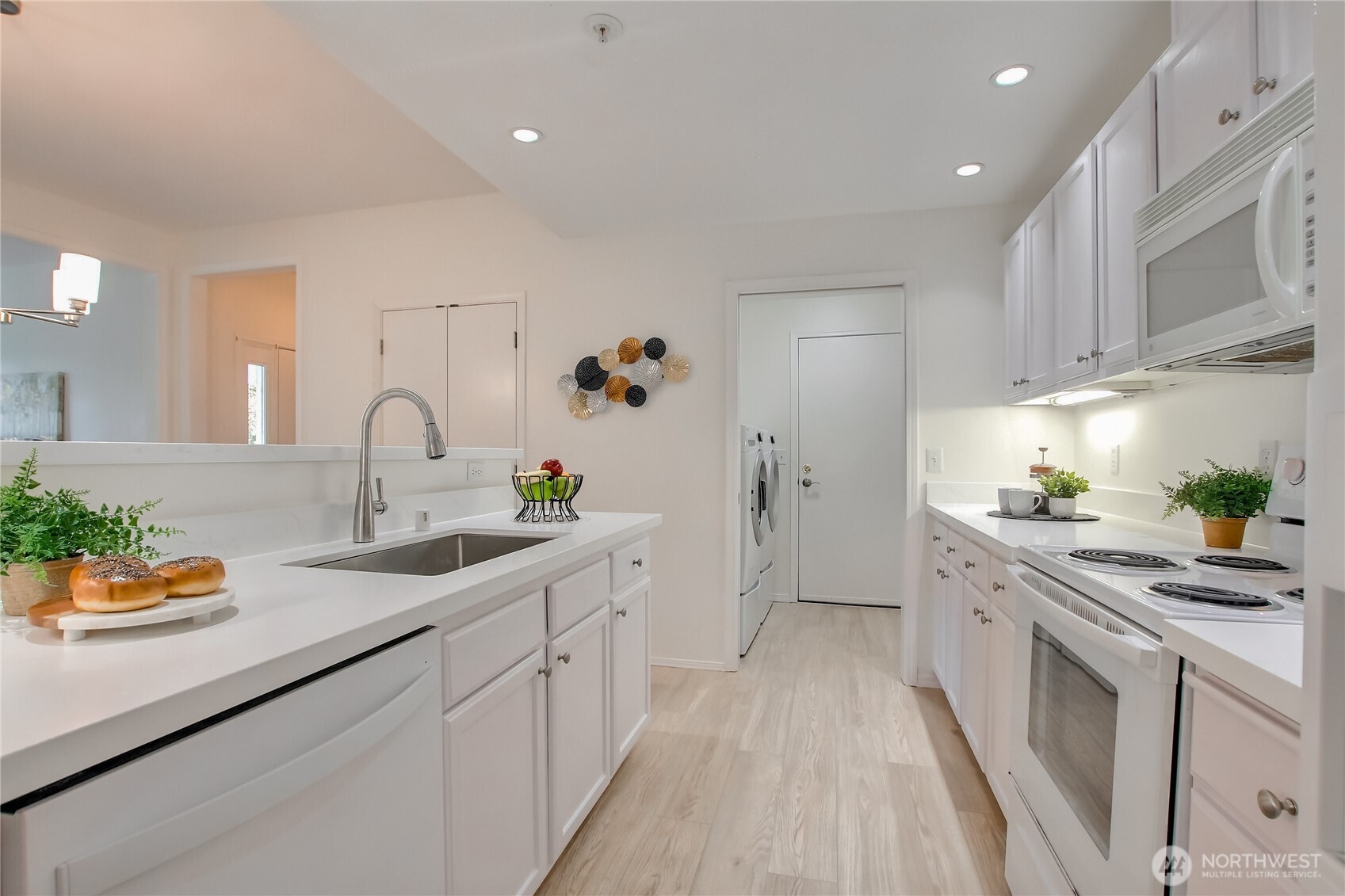 Spacious kitchen featuring a convenient pocket door leading to the laundry room, with direct access to the garage.