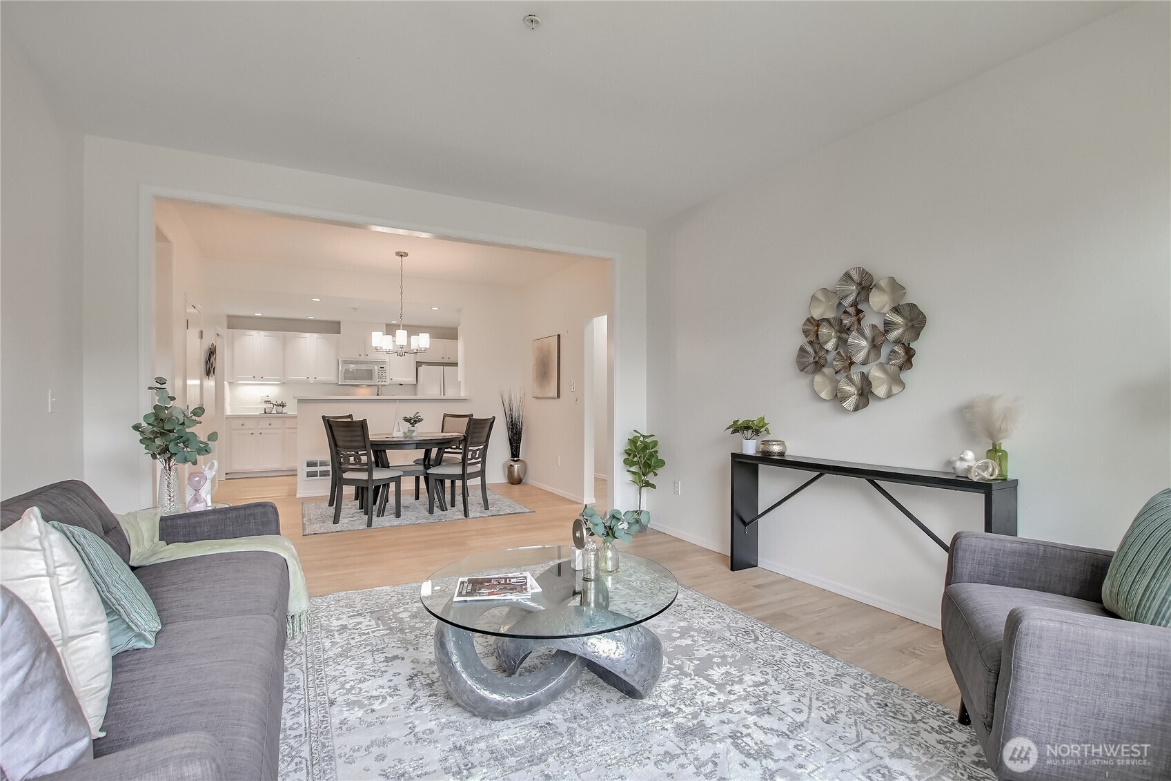 Living and dining area with open sight lines to kitchen