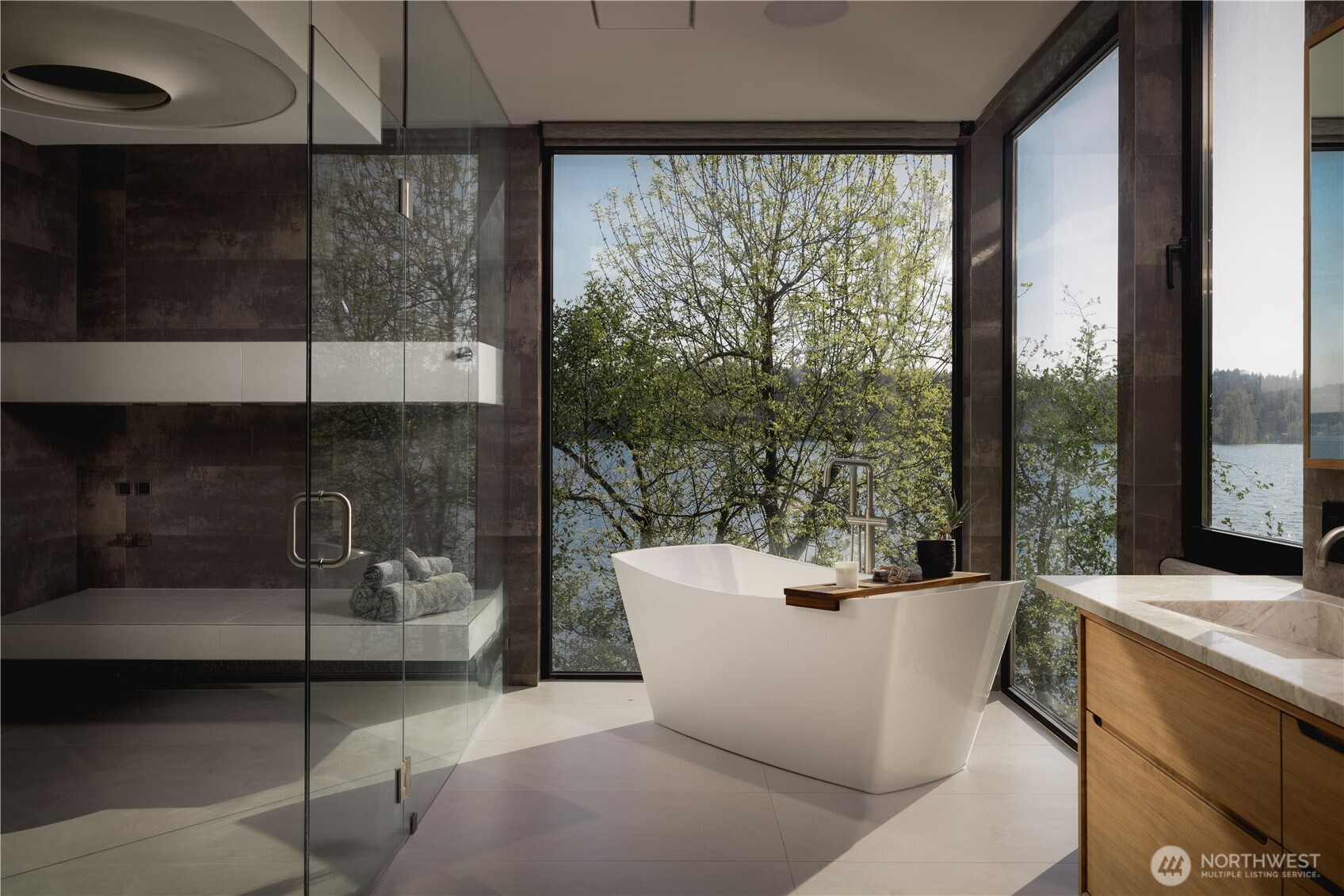 The primary bath is shaped as a complete wellness experience, centered around a Dornbracht AquaMoon shower with integrated light, rain, and aromatherapy, alongside a BainUltra air tub and a fully integrated spa system.